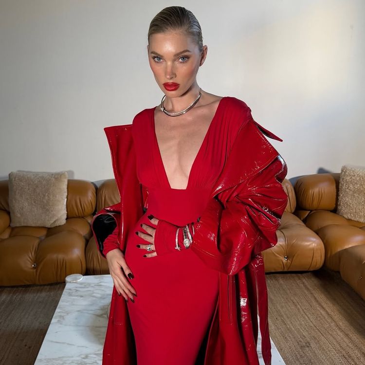 Elsa Hosk wears an all-red outfit, slicked back hair and red lipstick