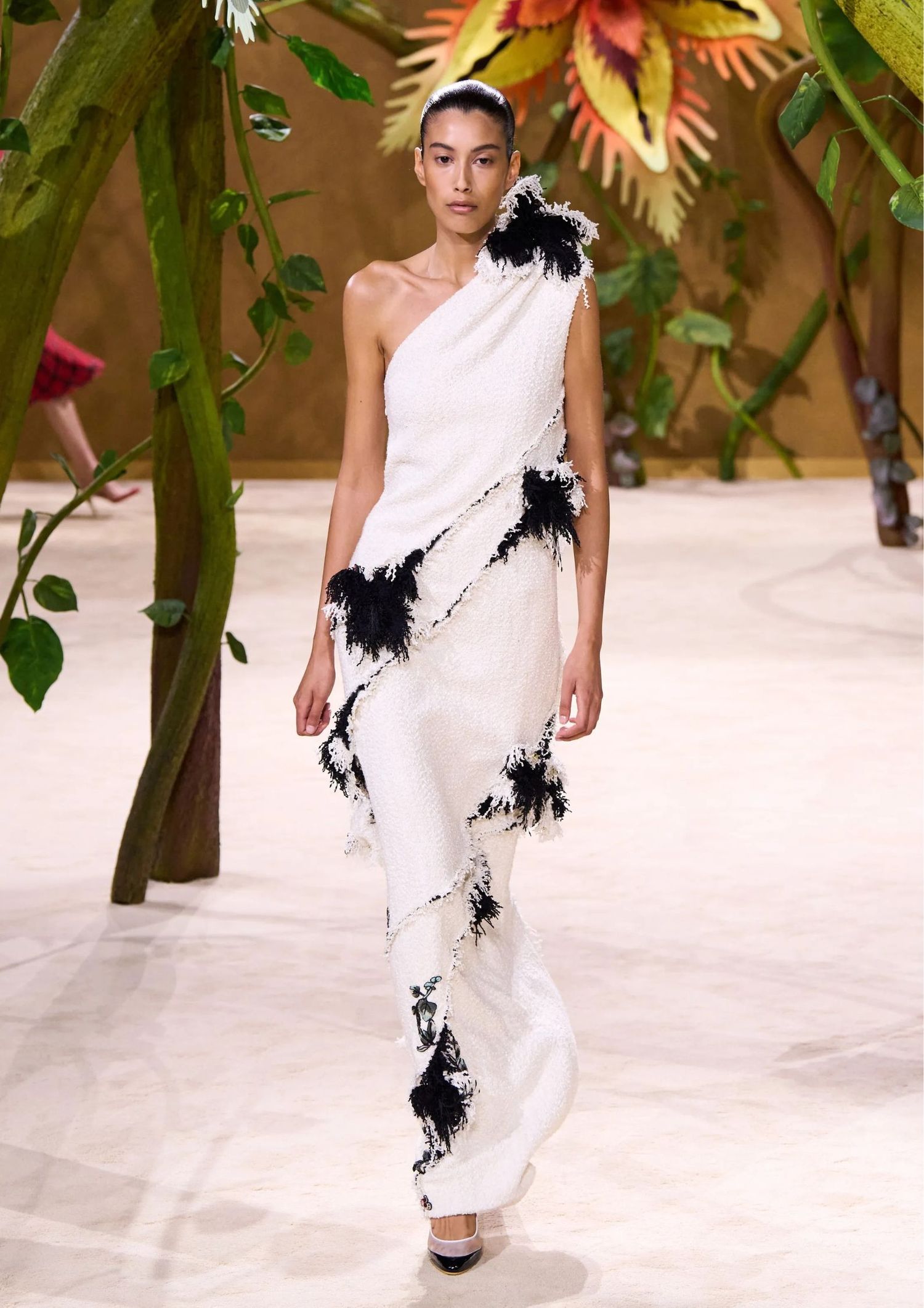 One-shoulder draped long dress with black feather appliqués