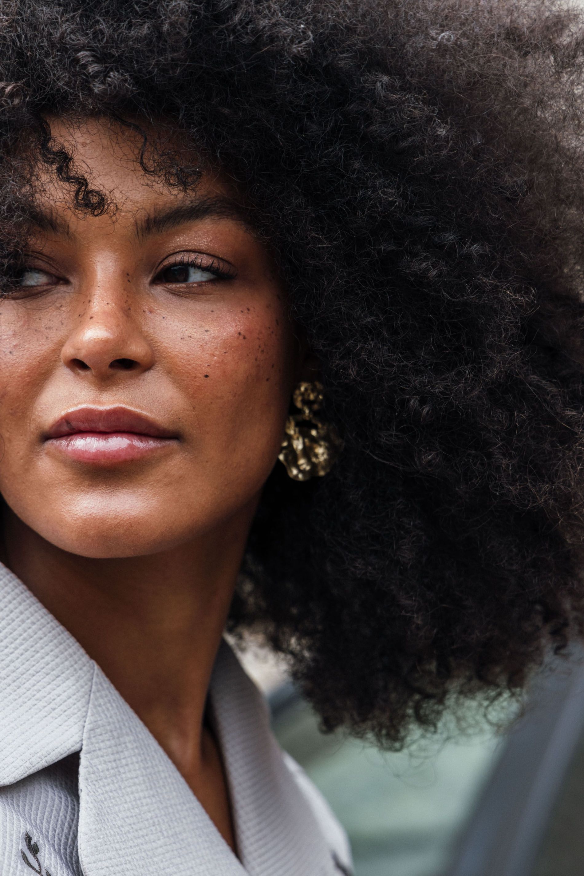 Guest wears a pair of gold statement earrings to Copenhagen Fashion Week SS24