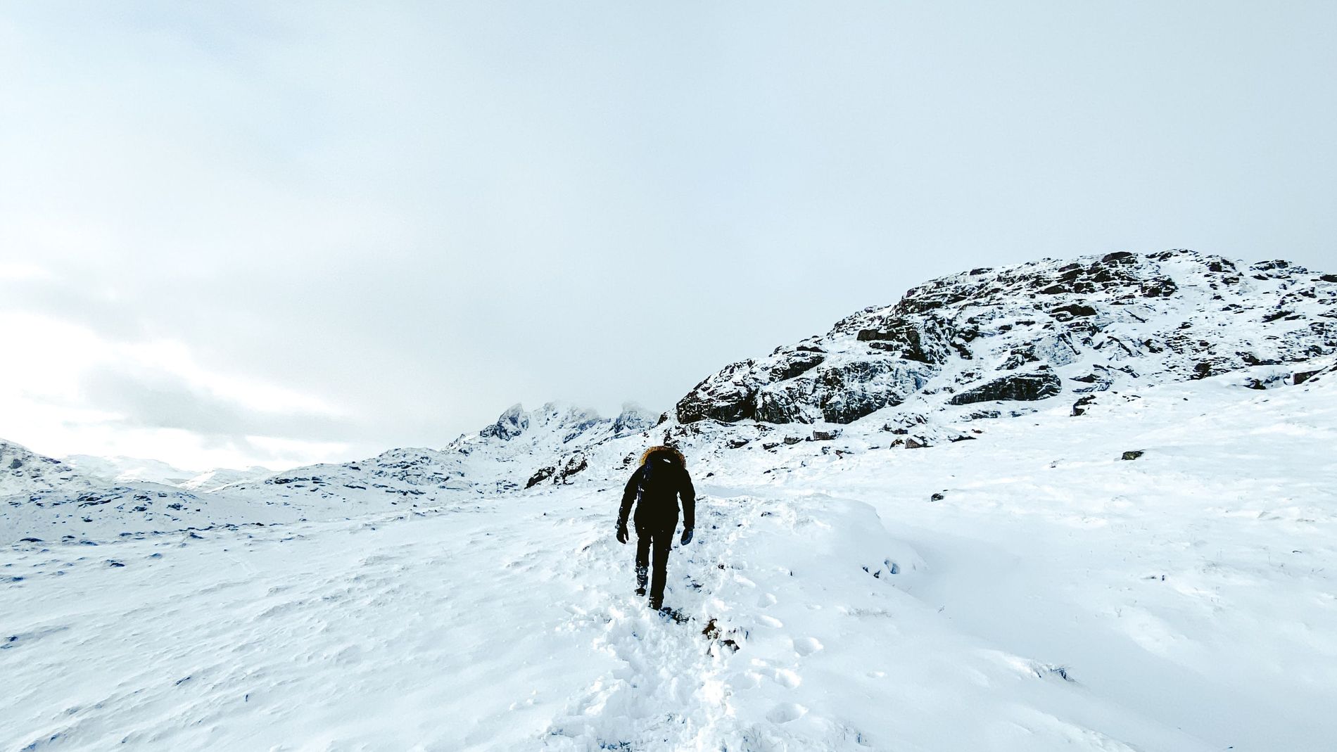 A person climbing a snowy mountain