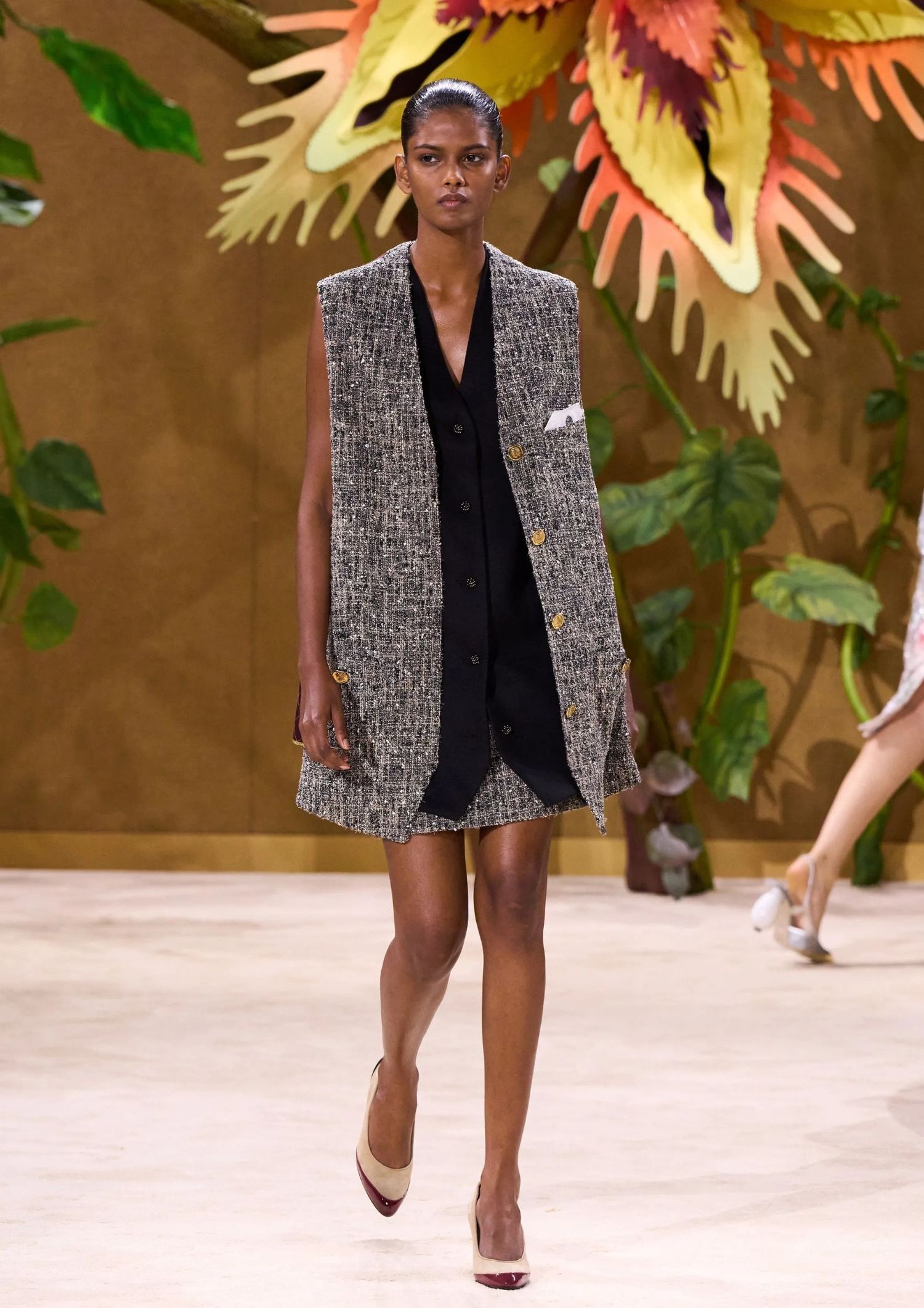 Sleeveless tweed longline vest, a black sleeveless top, a matching tweed mini skirt