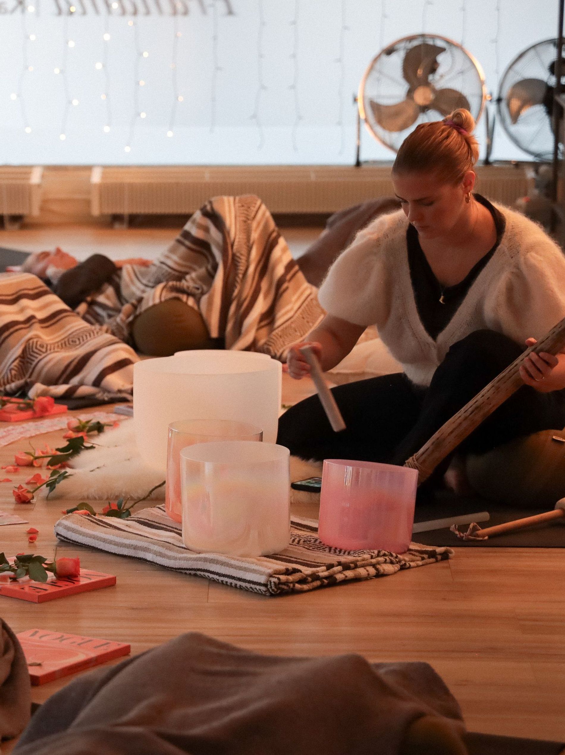 Woman practicing sound healing yoga in her studio