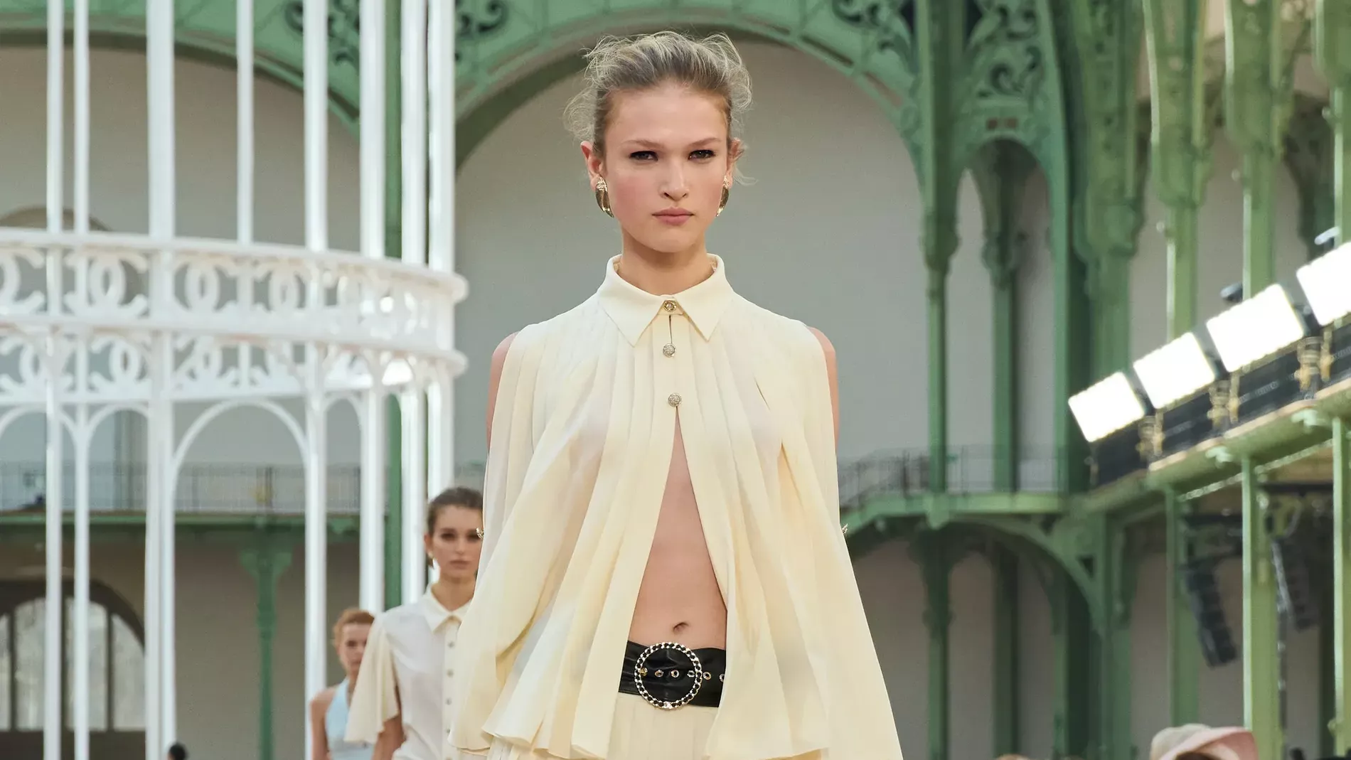 Chanel spring summer 2025 runway picturing a chiffon shirt and skirt in butter yellow 