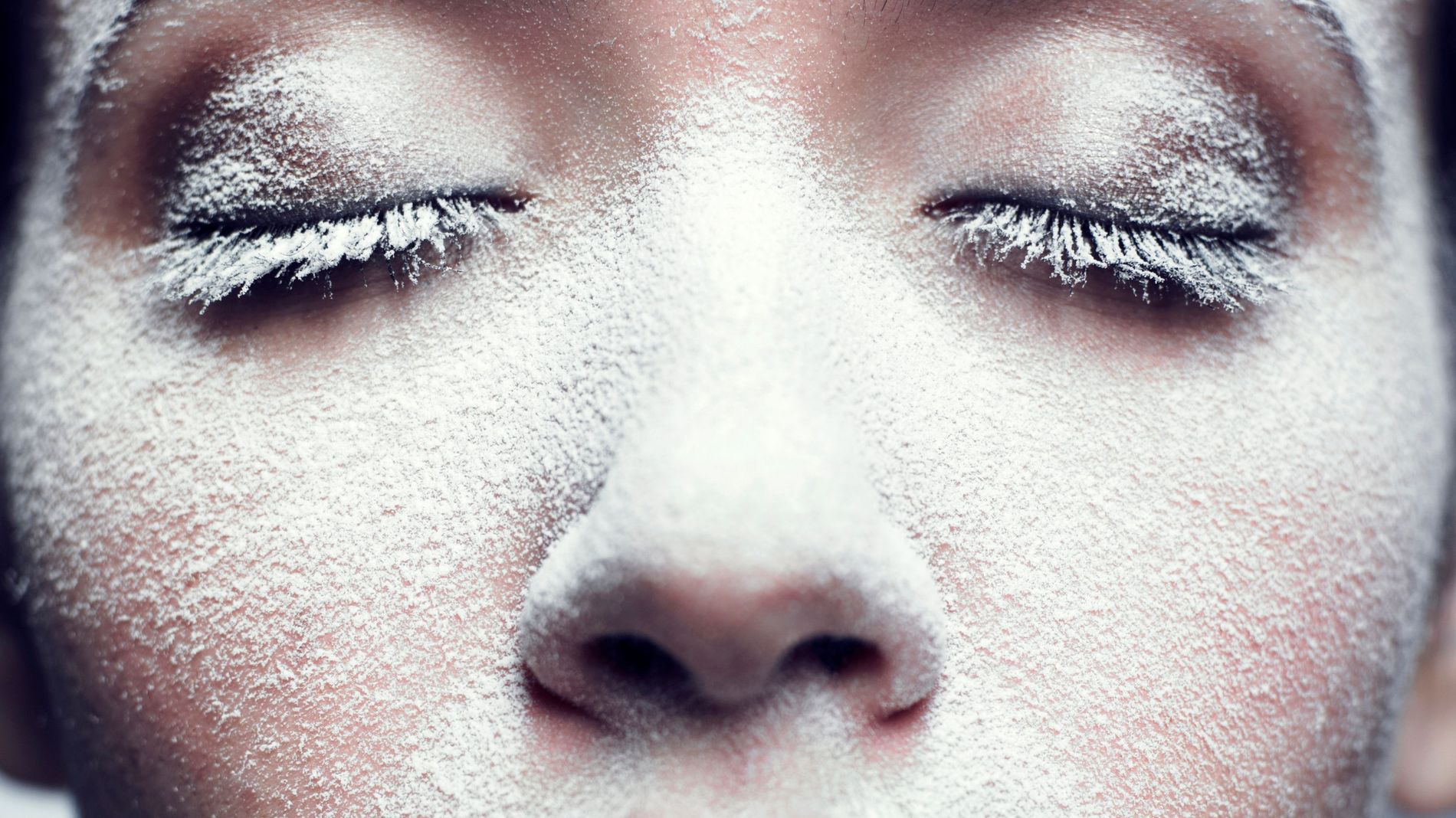 A model poses with and excess of setting powder dusted over her face