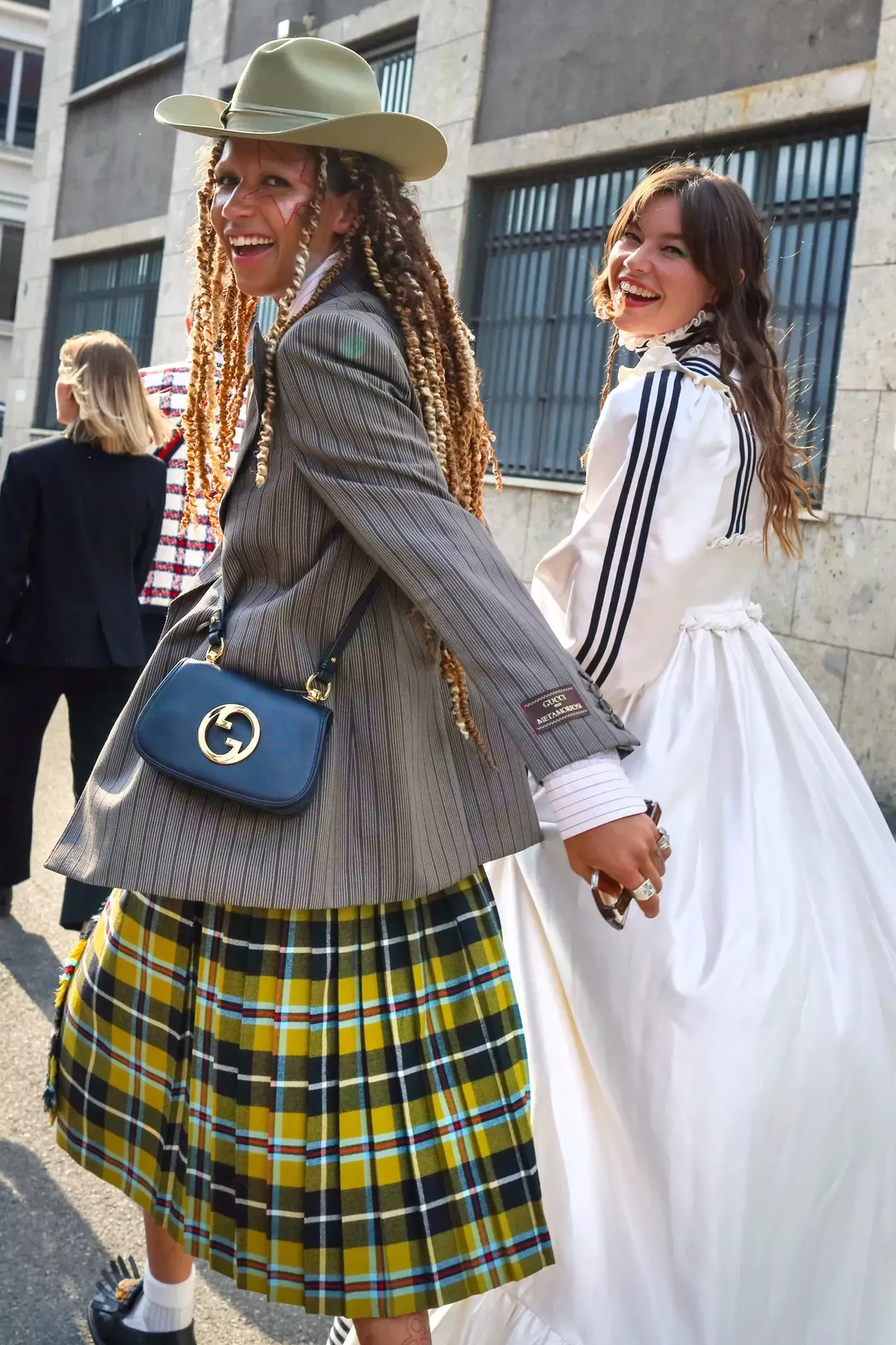 Milan Fashion Week AW23 guest wears pinstripe Gucci blazer and tartan skirt with cowboy hat