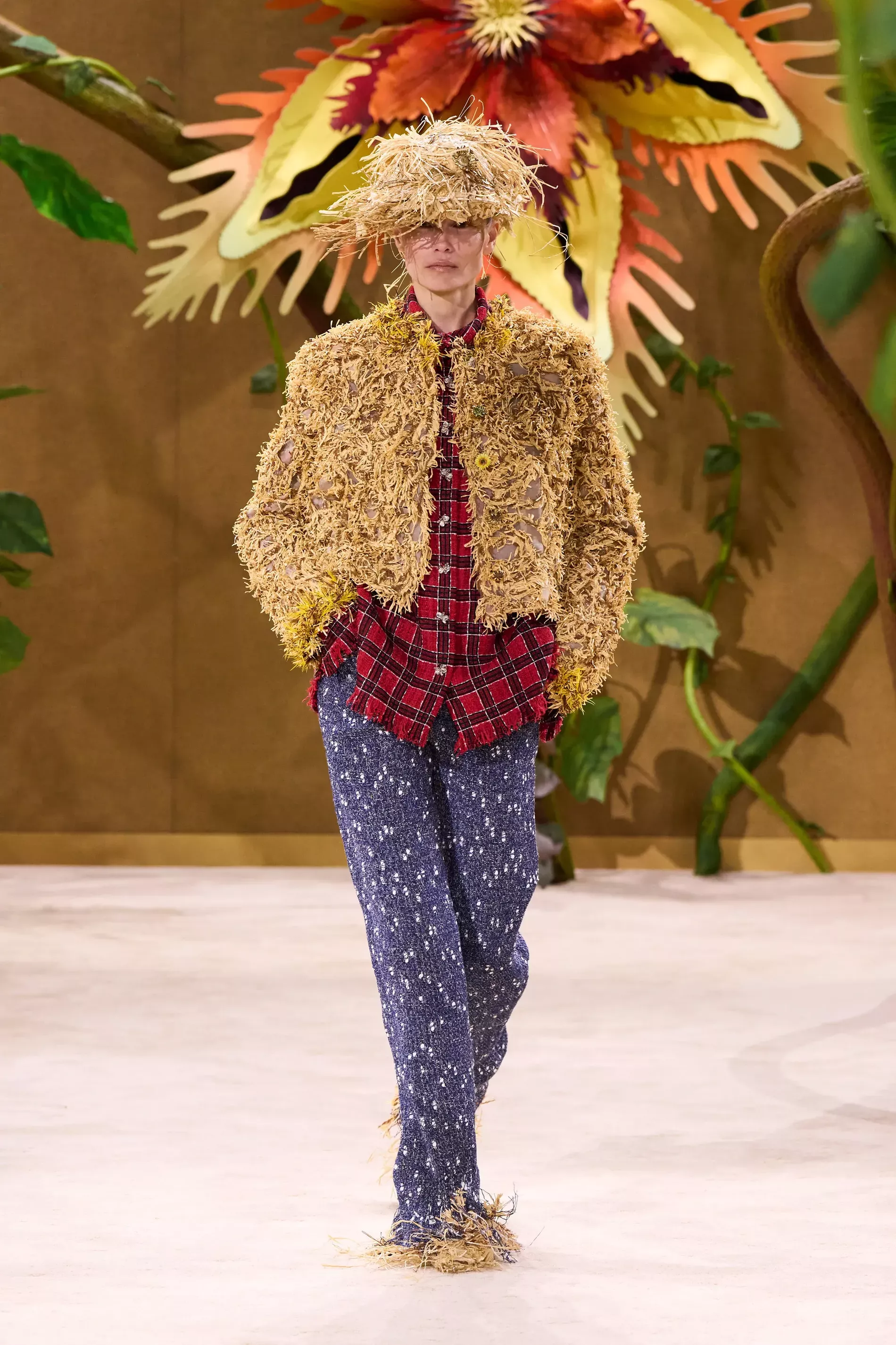 A textured jacket, matching fringed hat and shoes, a red flanell shirt, and shimmering blue trousers