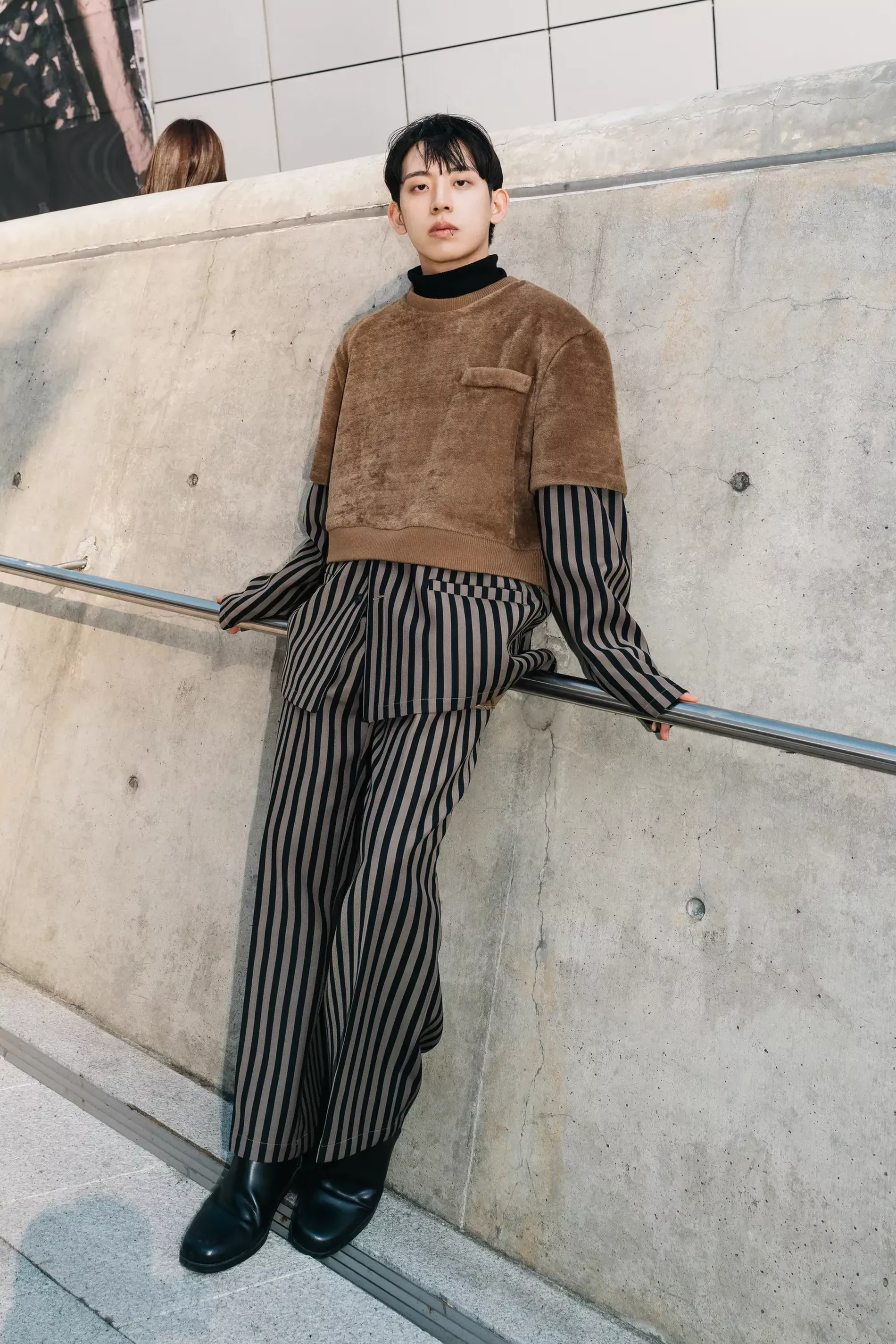 Seoul fashion week guests wears brown/black striped set with brown sweater
