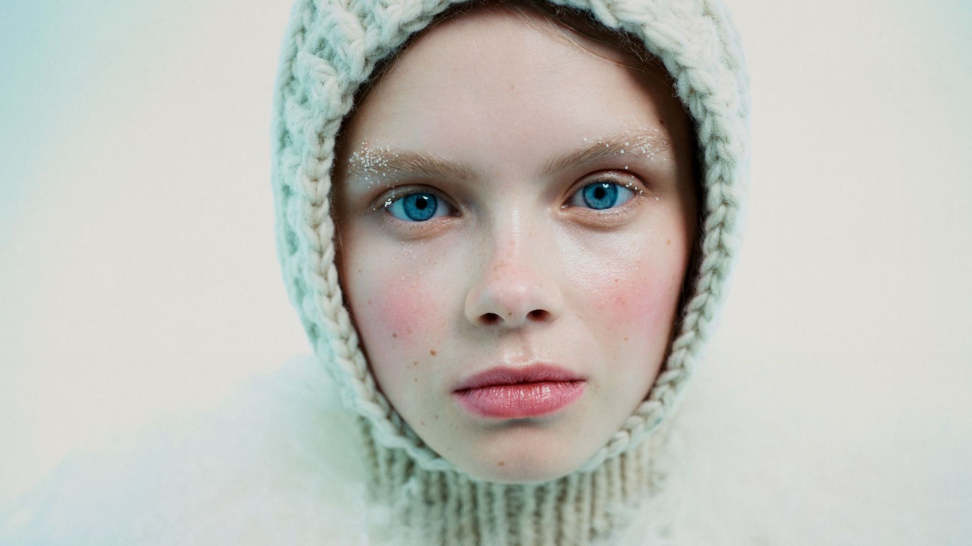 Model poses with red cheeks, snow-brushed brows and a balaclava