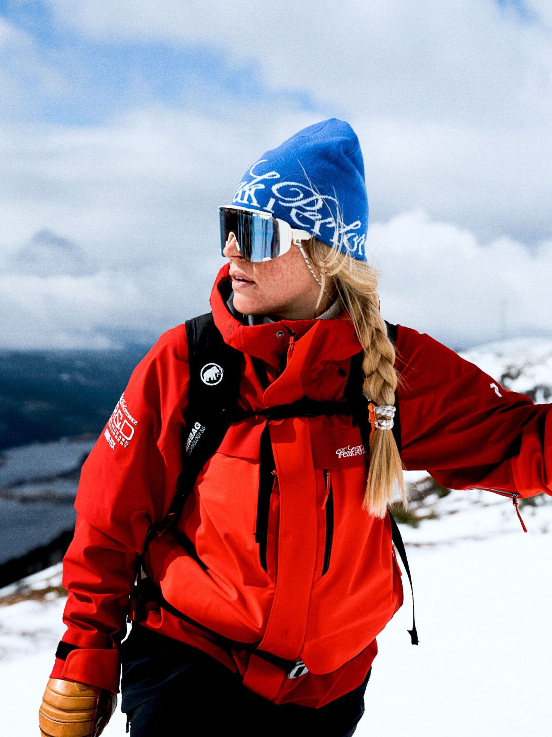 Athlete wears a red R&D long Peak Performance jacket on the slope