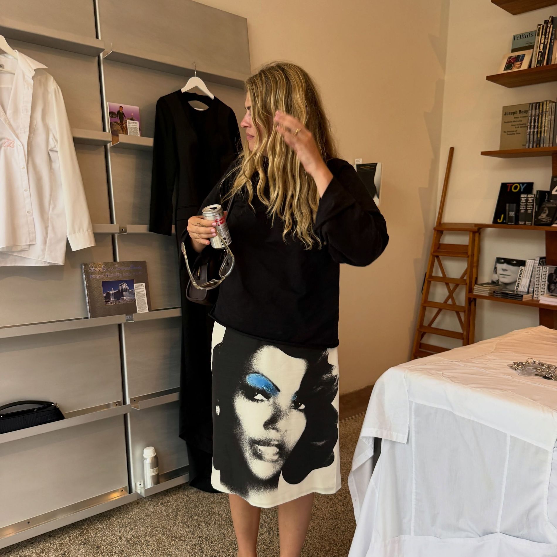 Sidsel Alling stands in a room wearing black jumper, black sandals and a Versace skirt