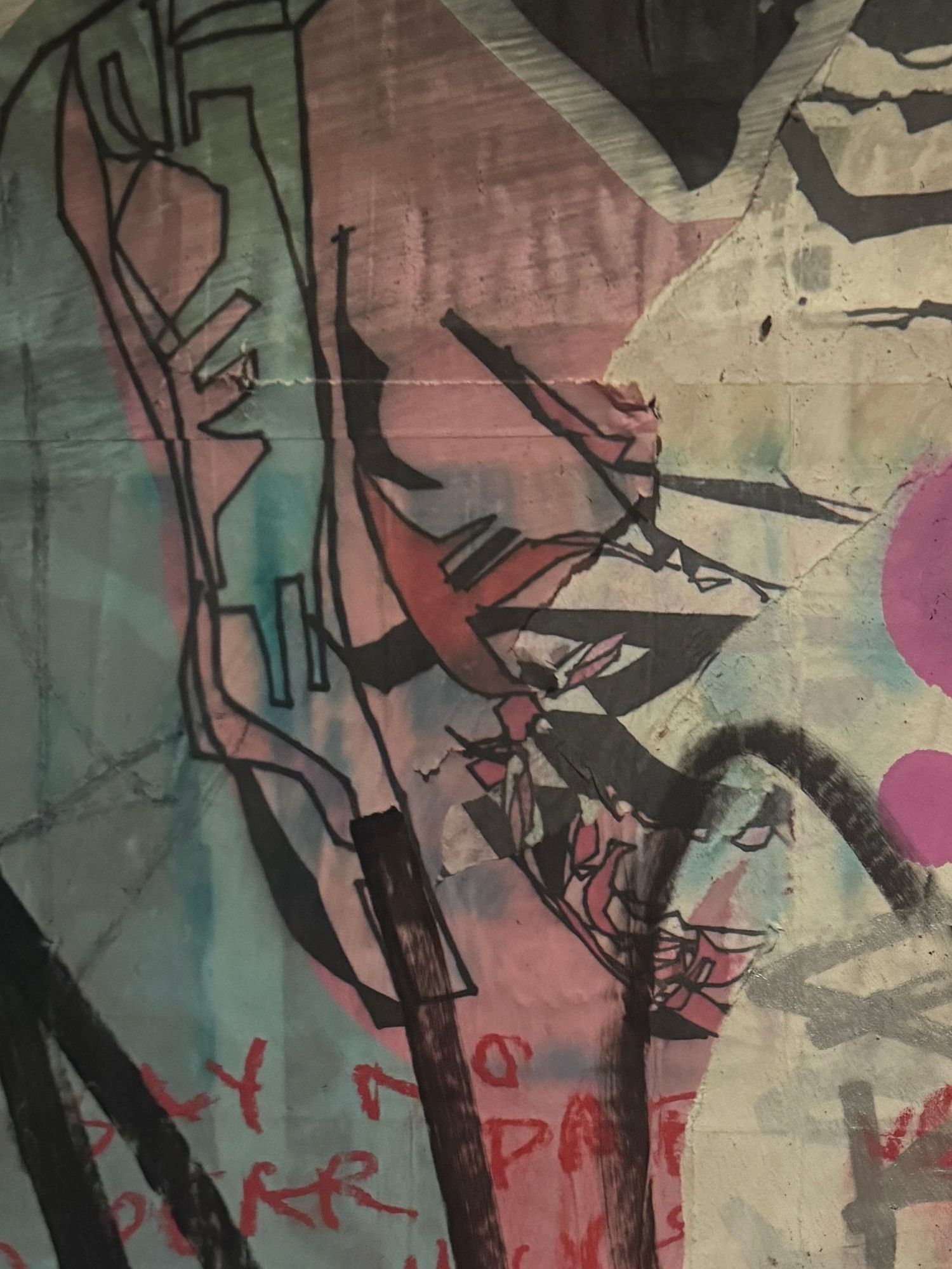 Layers of old coloured graffiti covering the toilet walls at Floss bar in central Copenhagen