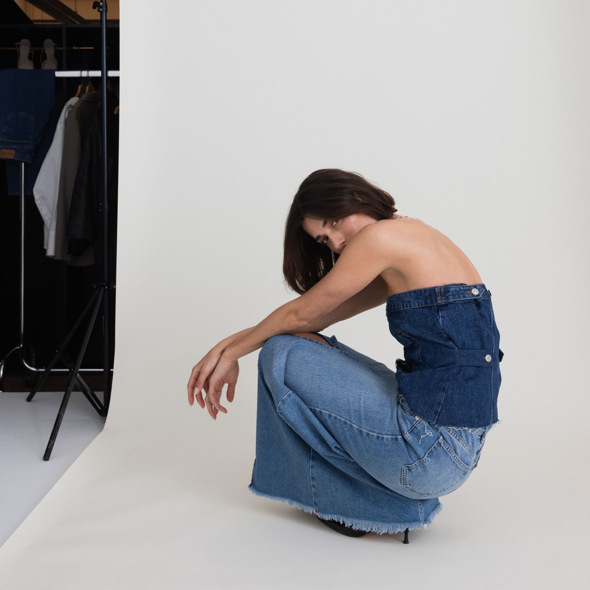 Model poses with remade denim pieces