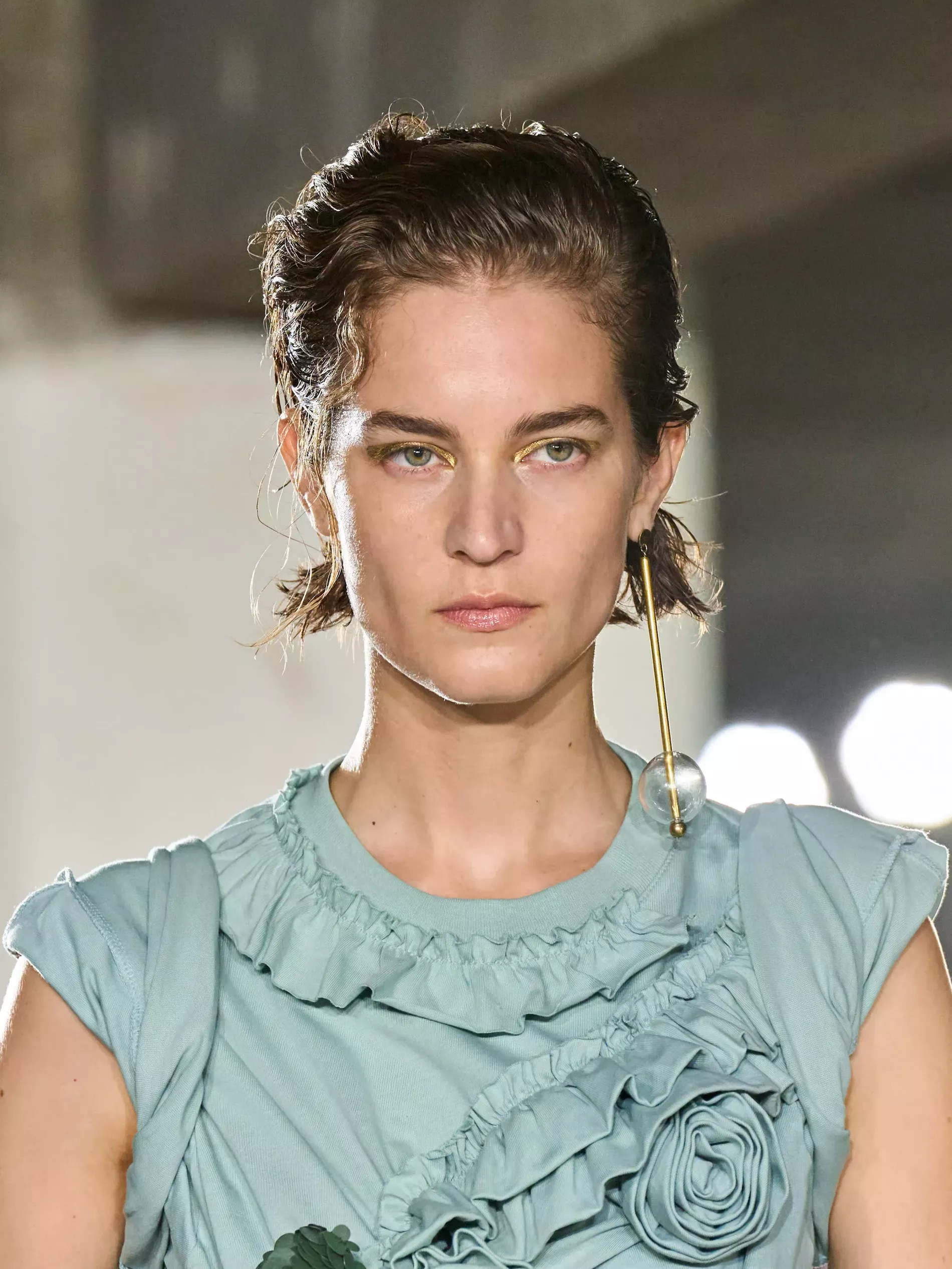 Model wears one statement earring on the runway of Dries Van Noten