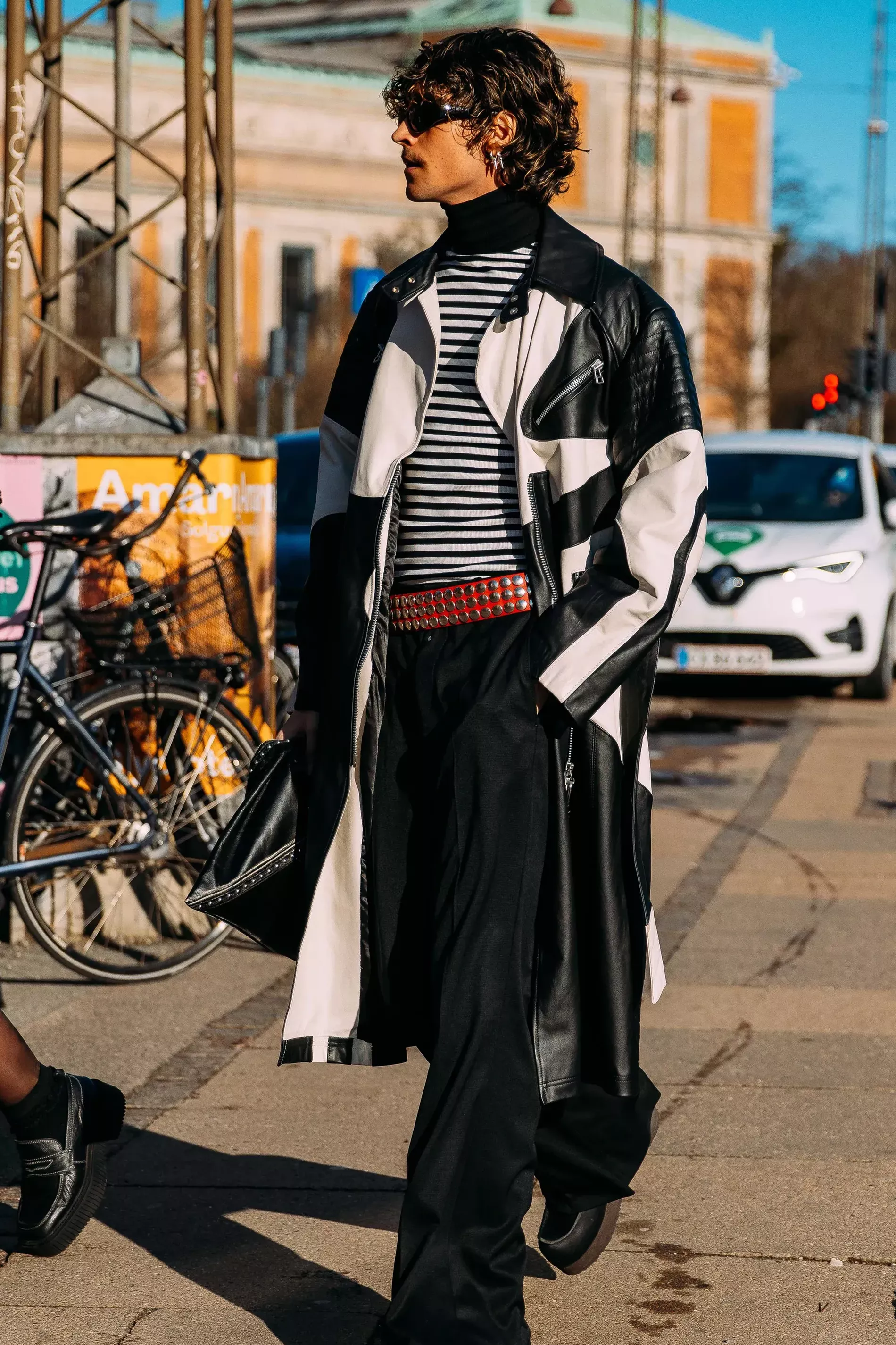 Copenhagen fashion week guest wears striped turtleneck under leather coat 