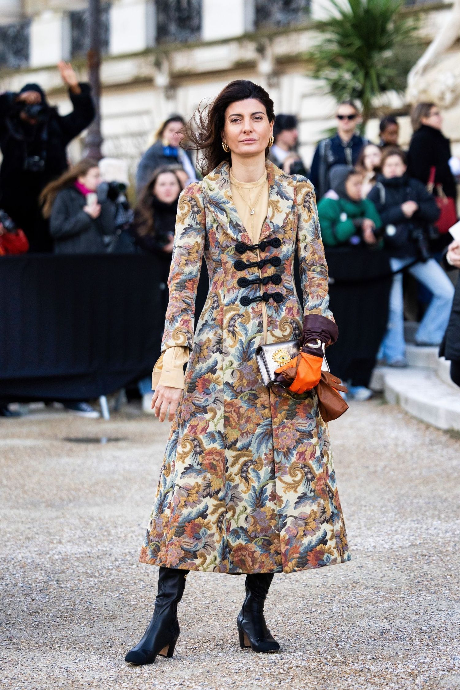 Giovanna Engelbert on the streets of Paris wearing patterned coat, black leather boots and Schiaparelli bag 