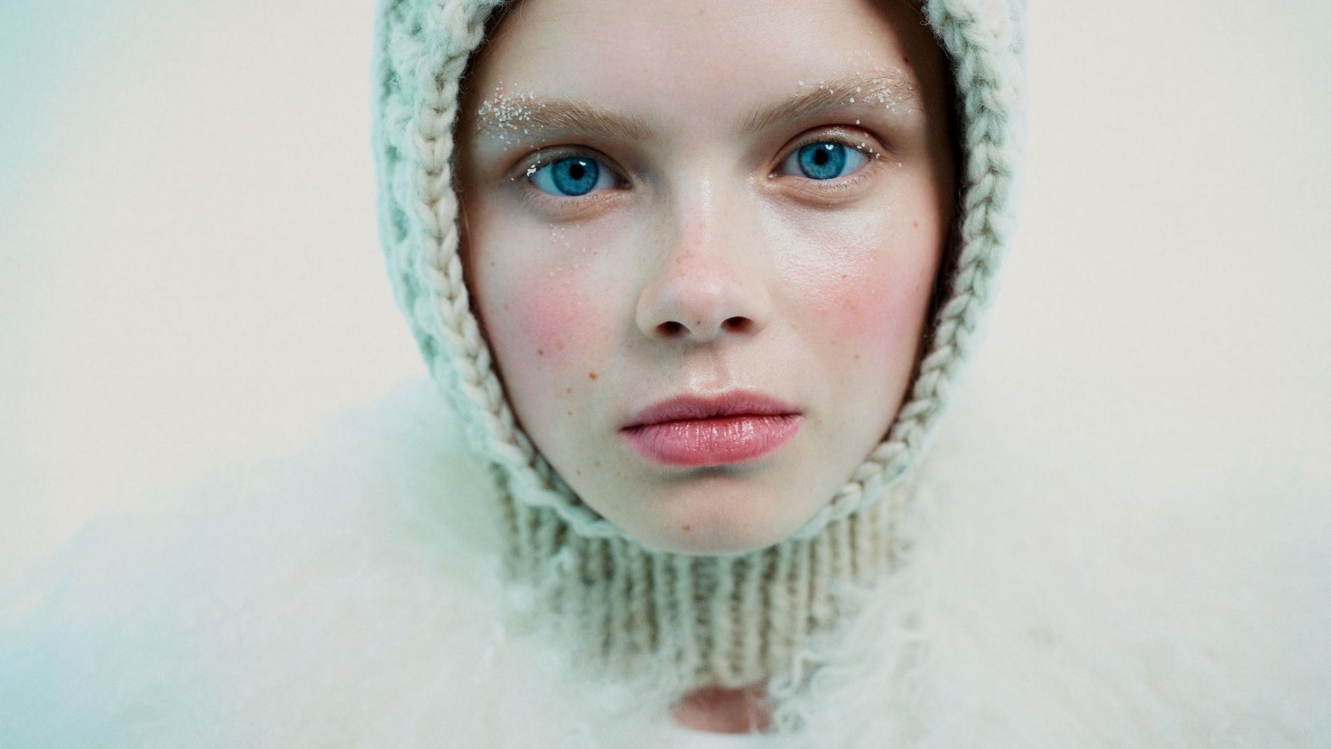 Model poses with red cheeks, snow-brushed brows and a balaclava