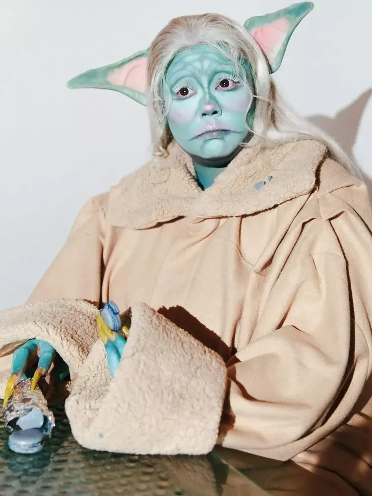 Lizzo dressed as Baby Yoda. 