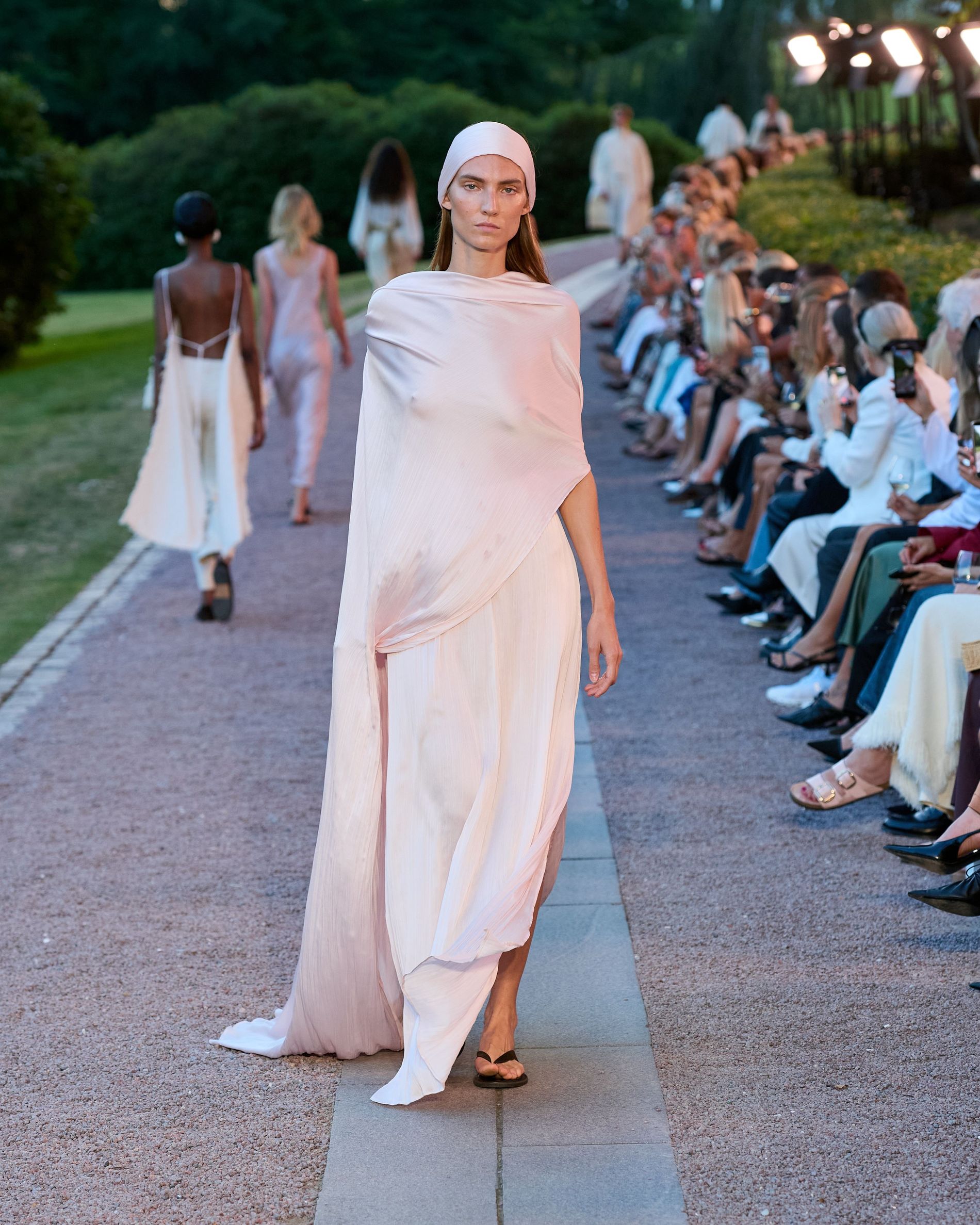 Floor length satin cape dress paired with a headband