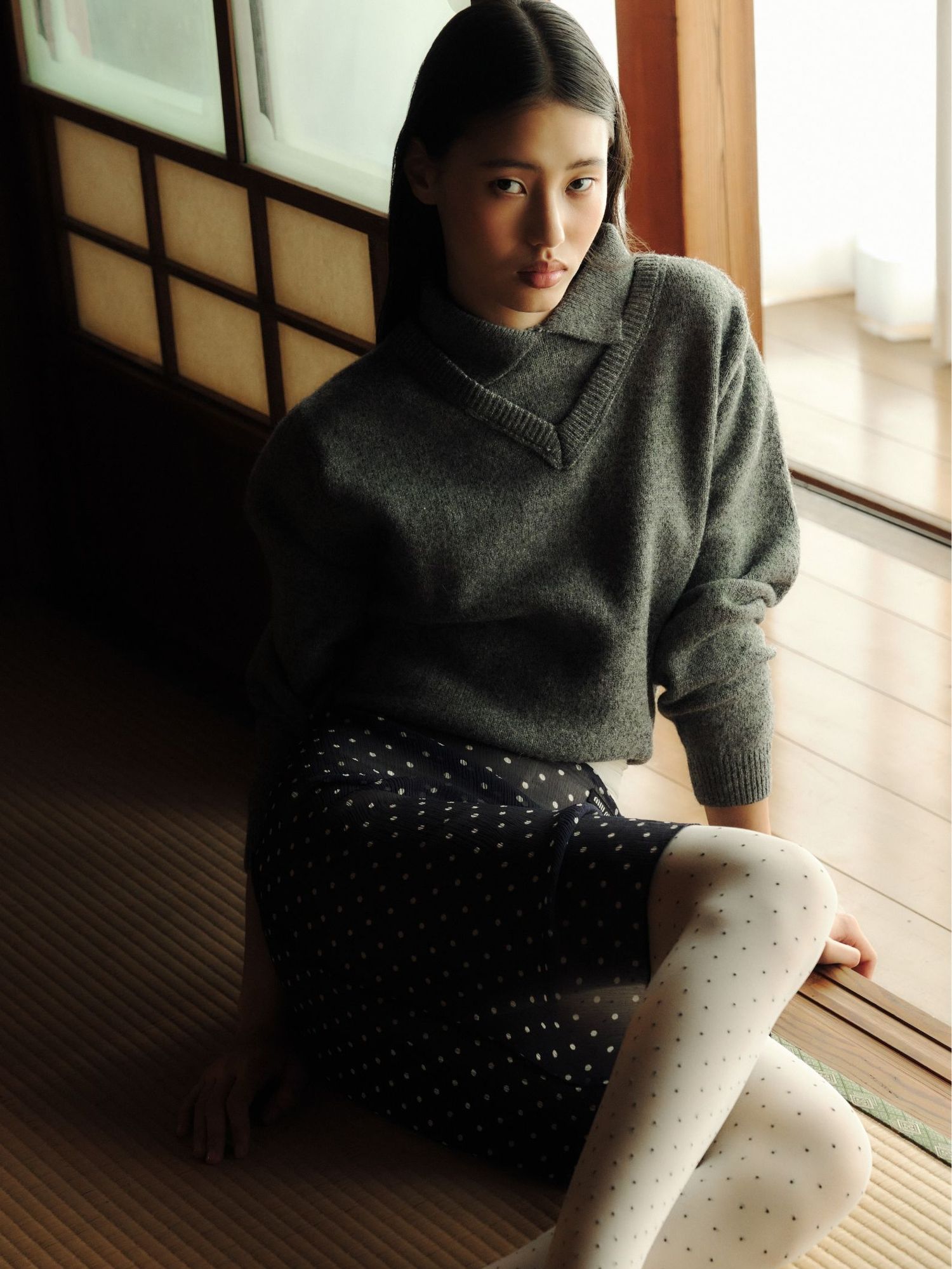 A stunning model sitting on the floor in Japan 