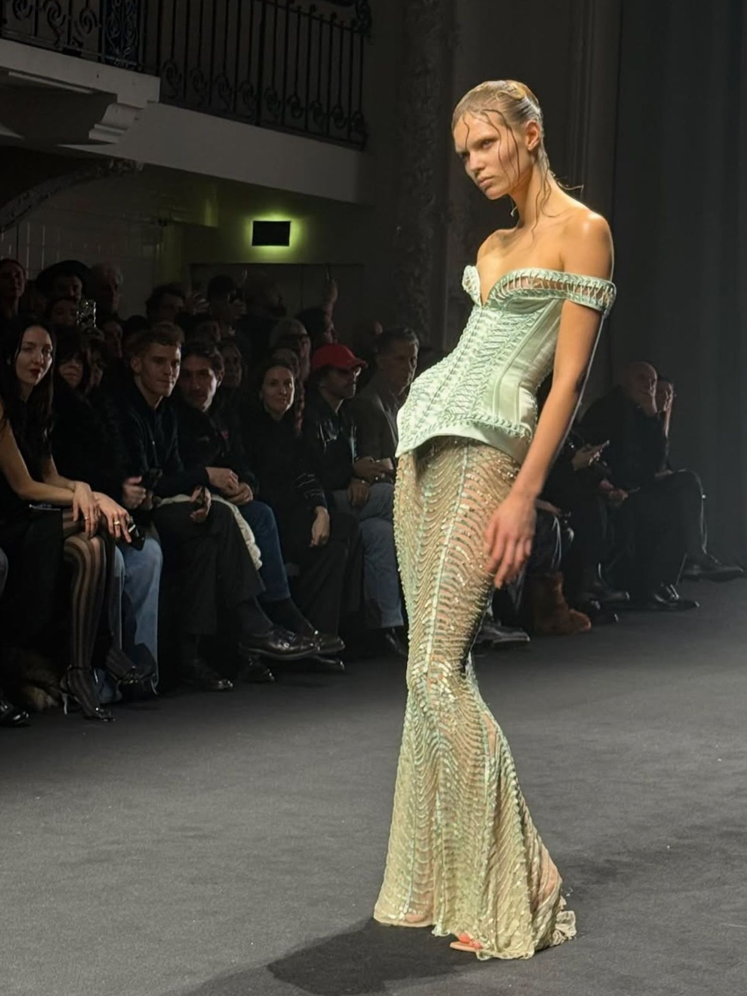 Ida Heiner walking the Jean Paul Gaultier couture show in Paris wearing a light green dress 