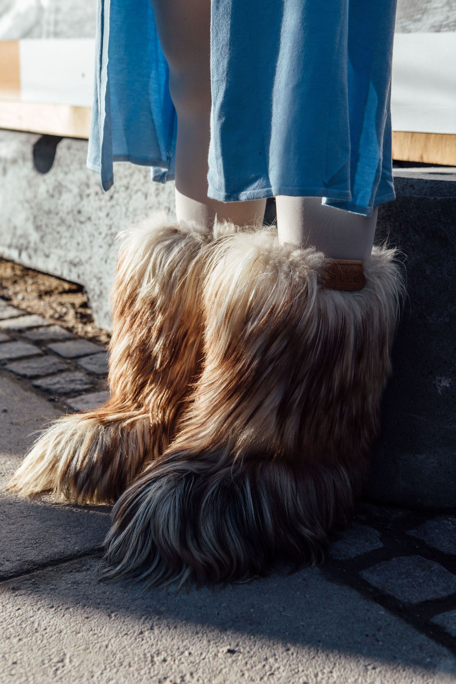 A guest wear faux fur boots at Copenhagen Fashion Week AW23