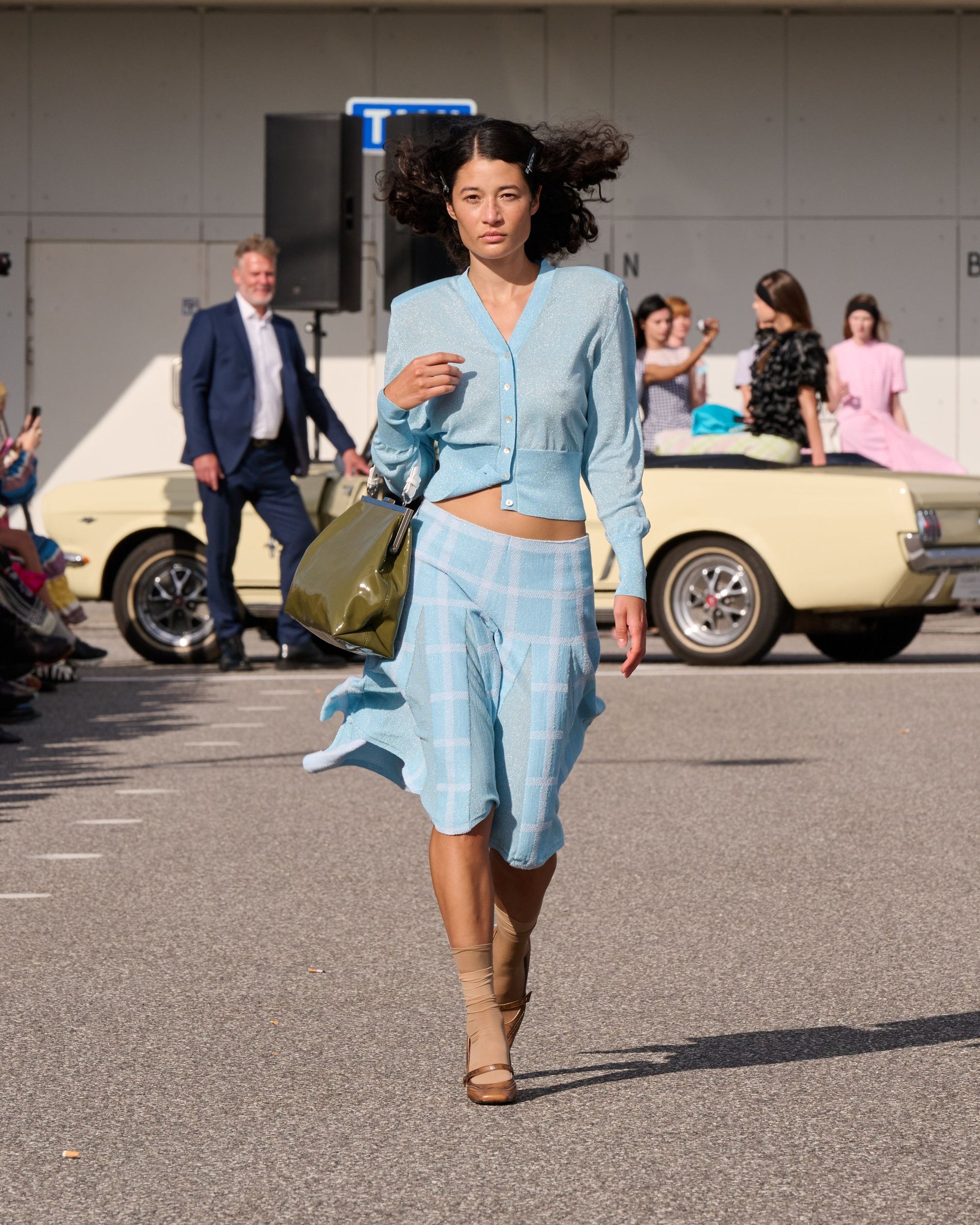 Blue knitted cardigan and blue checked skirt