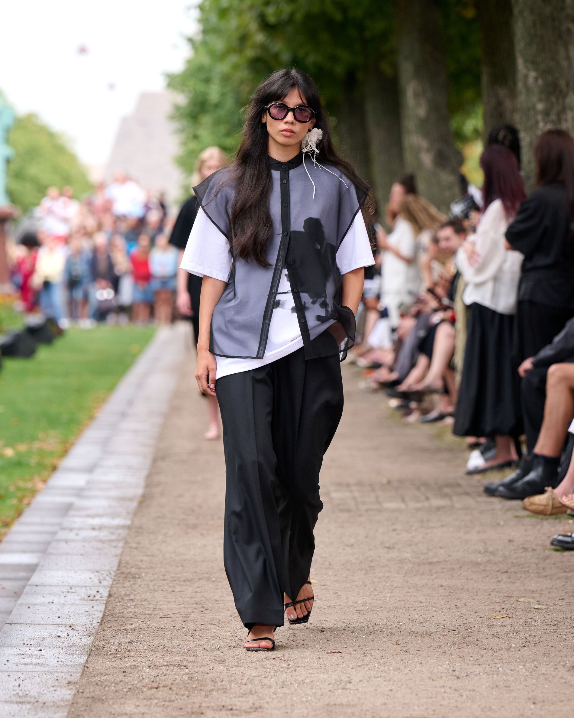 Transparent vest layered over a white t-skirt