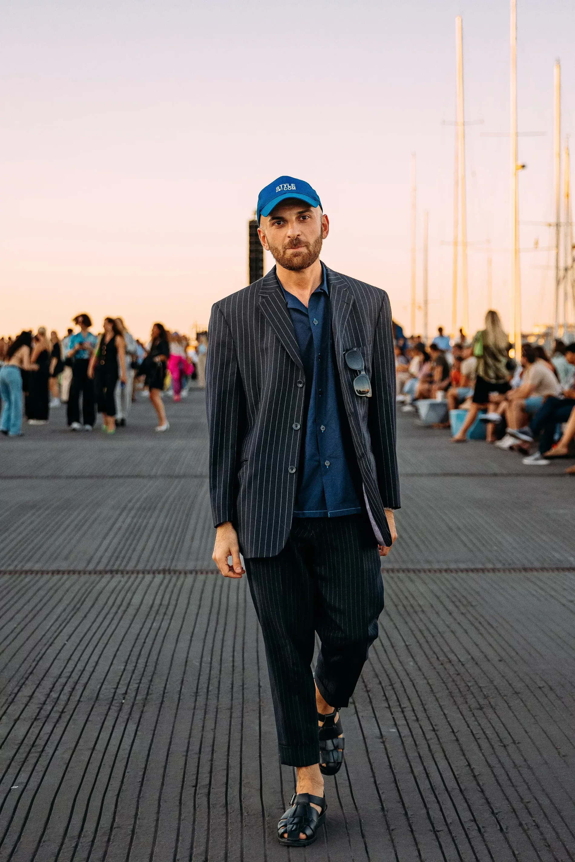 Copenhagen Fashion Week guest wears pinstripe blazer and pants with dark blue shirt