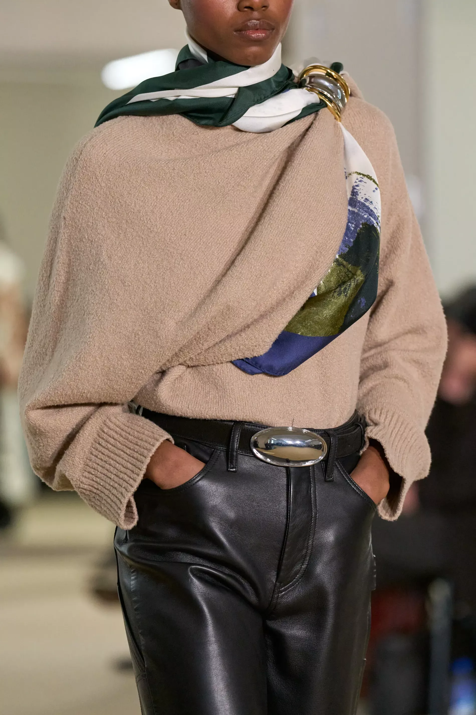 A close-up detail of a scarf pin in gold and silver at Altuzarra's fall/winter 2026 ready to wear show