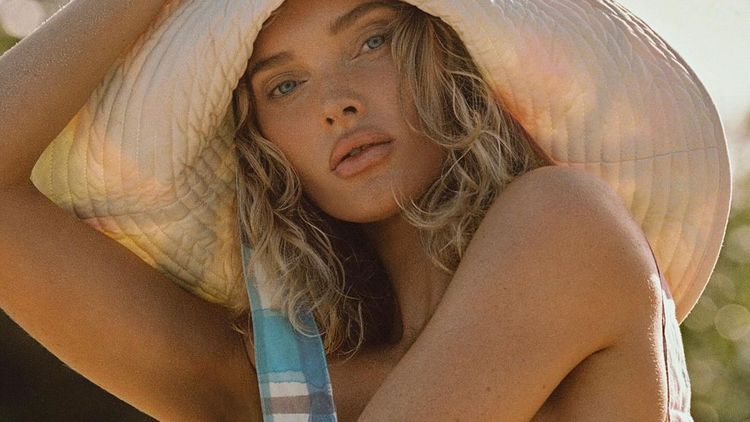 Elsa Hosk in a sunhat, embodying effortless summer skin and daily sun protection.