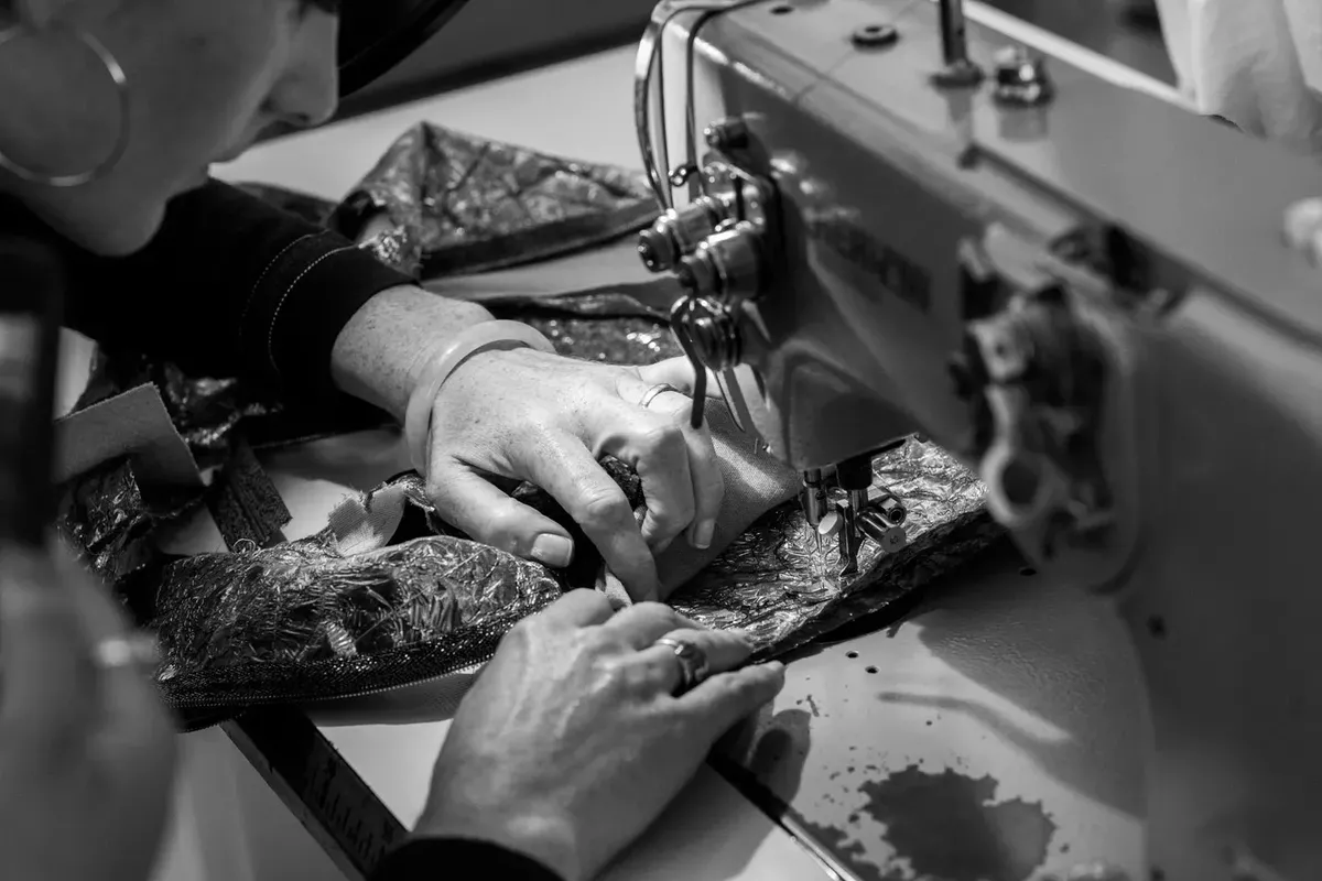 One of Chanel's seamstresses sews inside the Chanel atelier