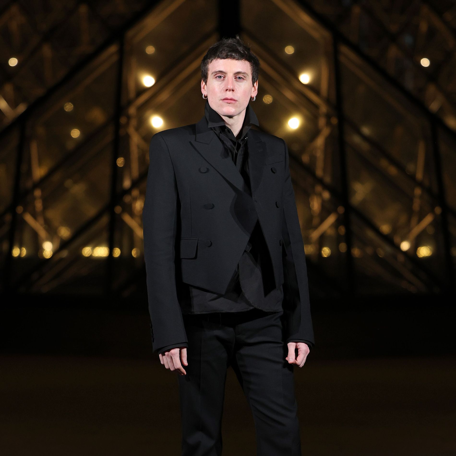 Sean McGirr former creative director of Alexander McQueen stands outside of the Louvre, during a dinner in Paris