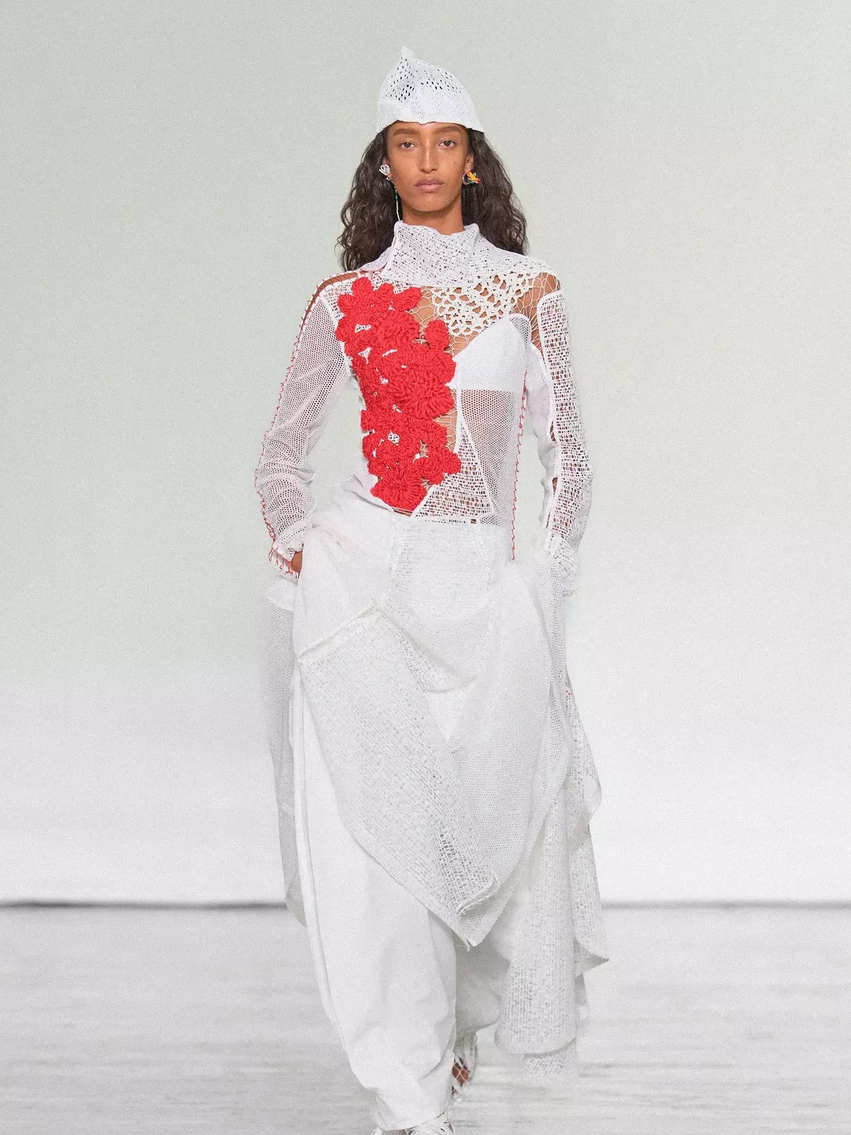 Mona Tougaard walks Bottega Veneta in an all white look with red floral accent