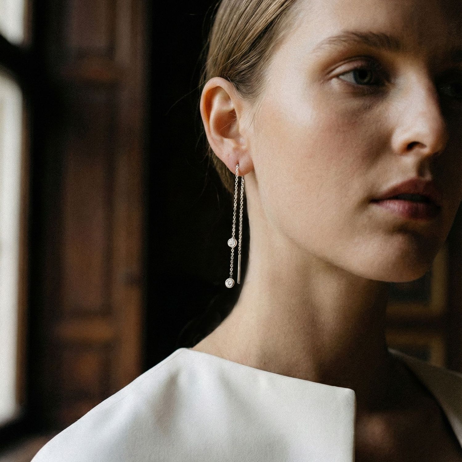 A model wears Ton Ton's diamond threader earring in white gold