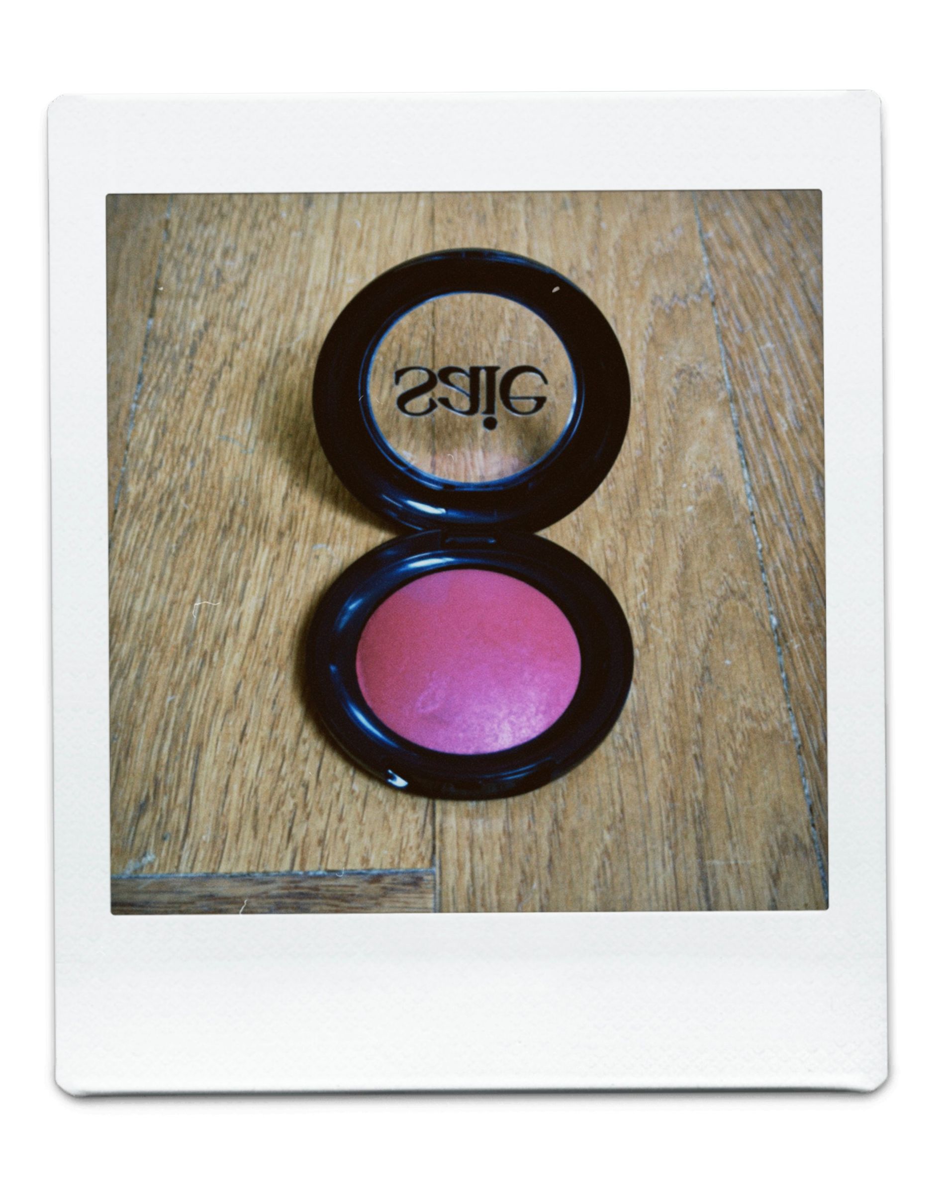 A pink blush on a black container
