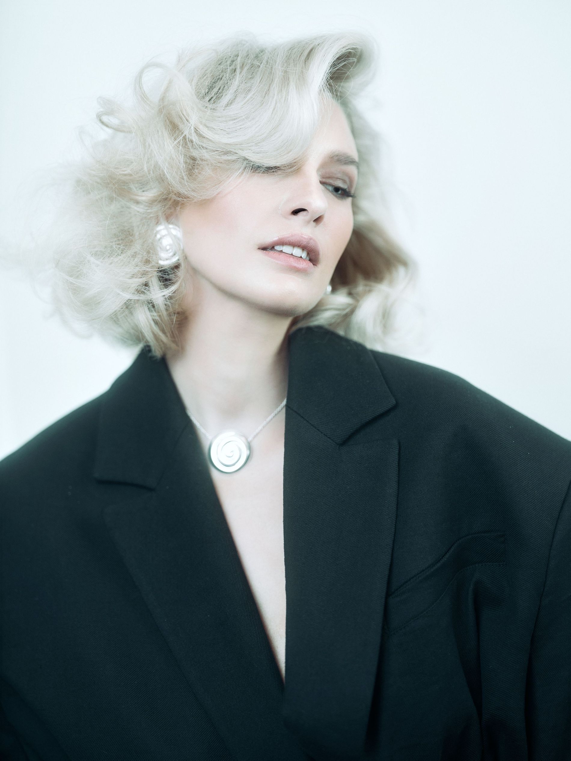 Model with Hollywood Glamour 'Swedish Grace' waves in short blonde hair