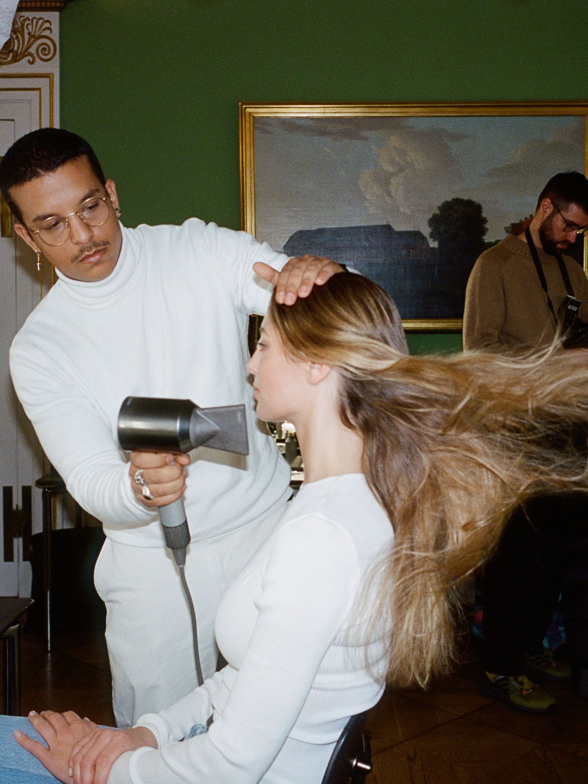 A model gets her hair blowdried backstage at the Garment's AW24 Copenhagen Fashion Week Show