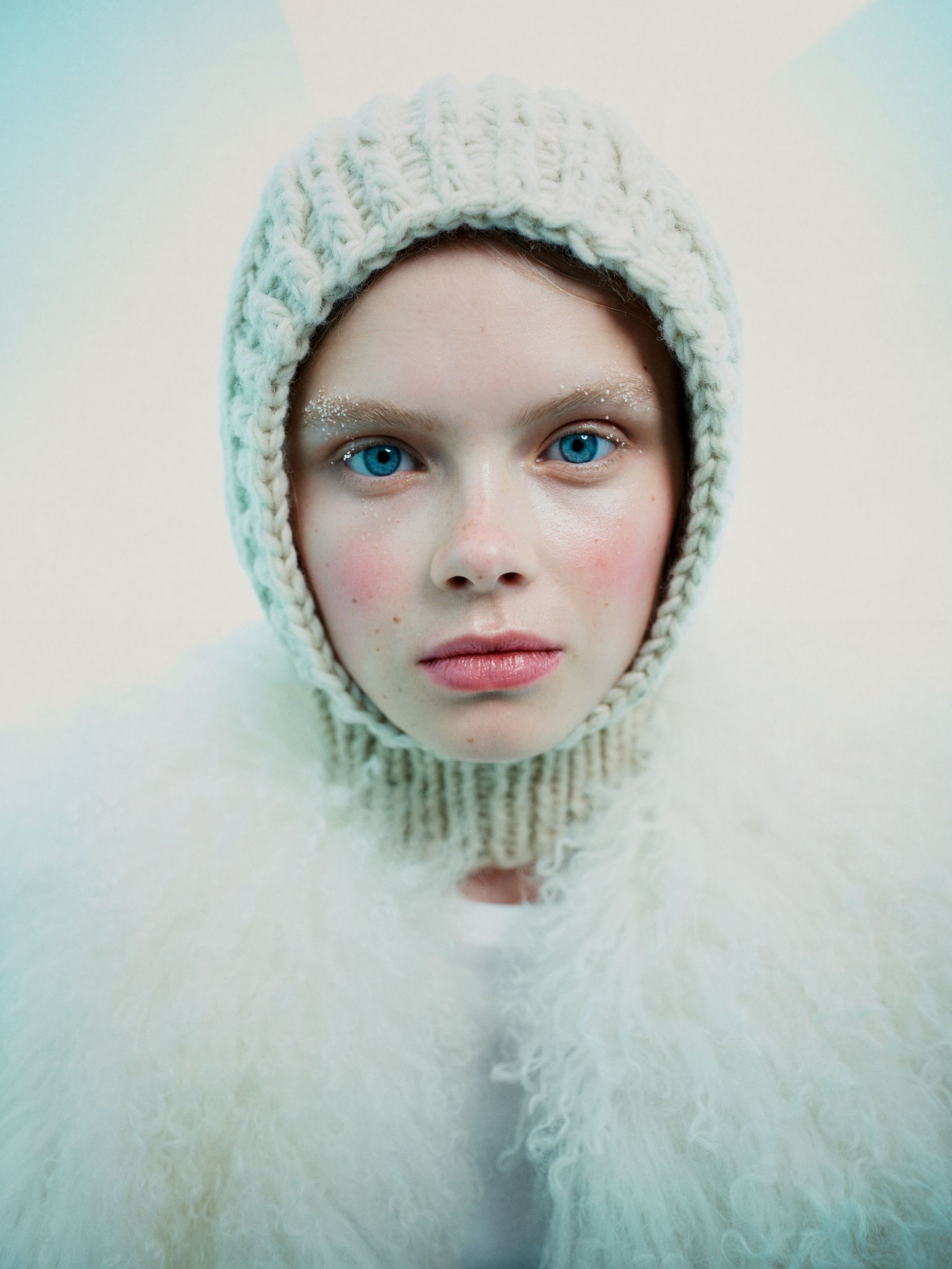 Model poses with red cheeks, snow-brushed brows and a balaclava