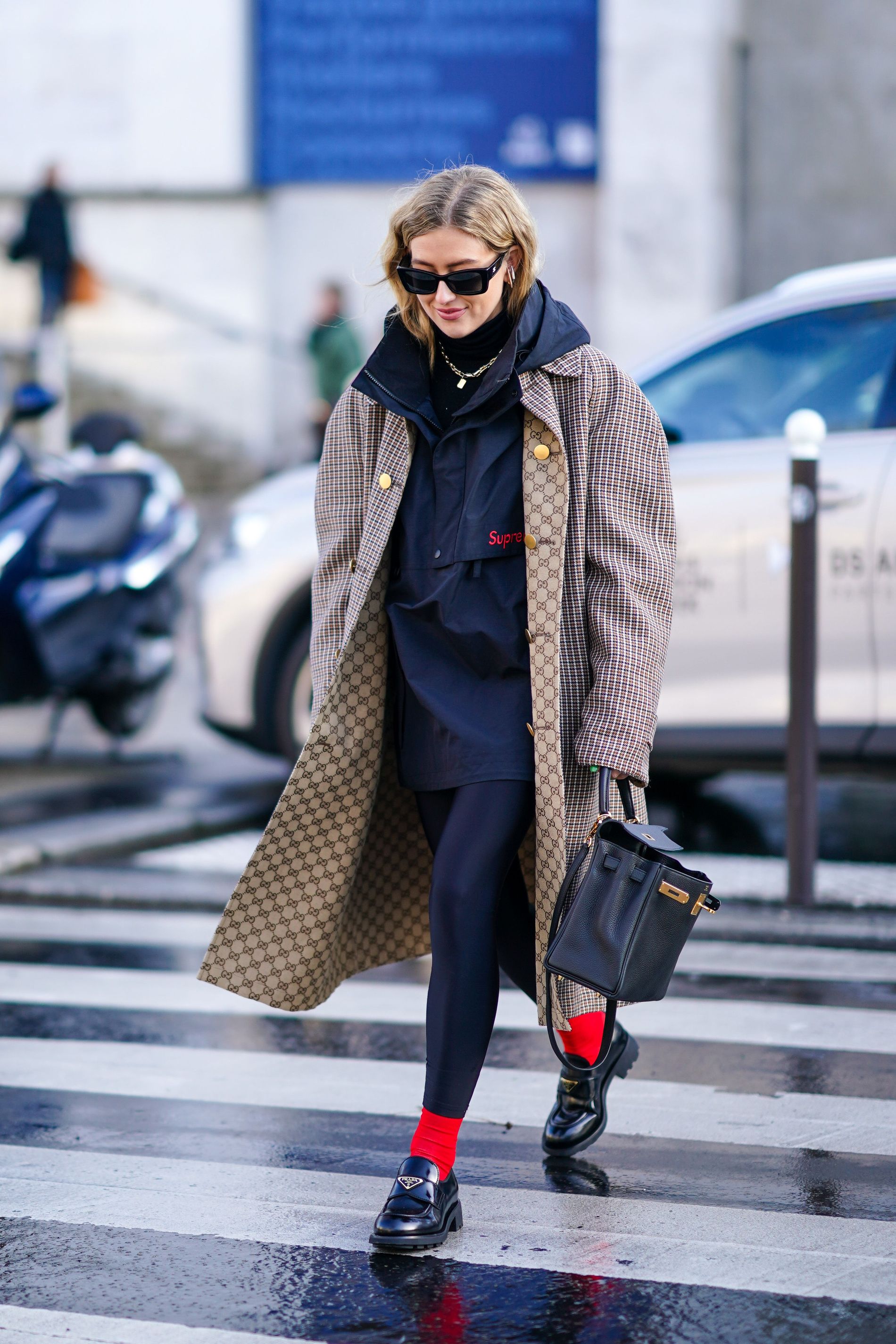 Emili Sindlev wears Prada loafers during Paris Fashion Week.