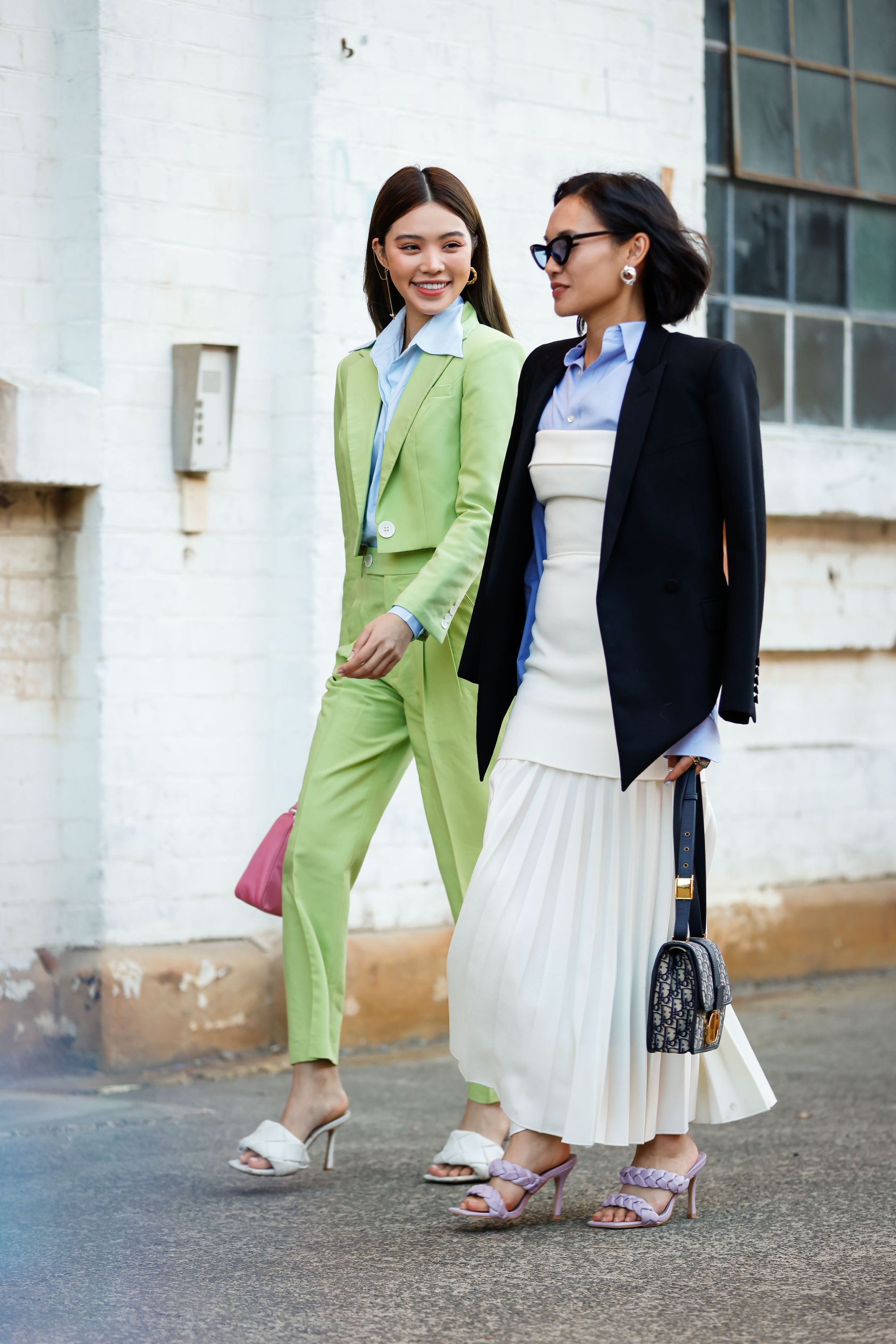 Jolie Nguyen and Christine Ai wearing Bottega Veneta mules in Sydney, Australia. 