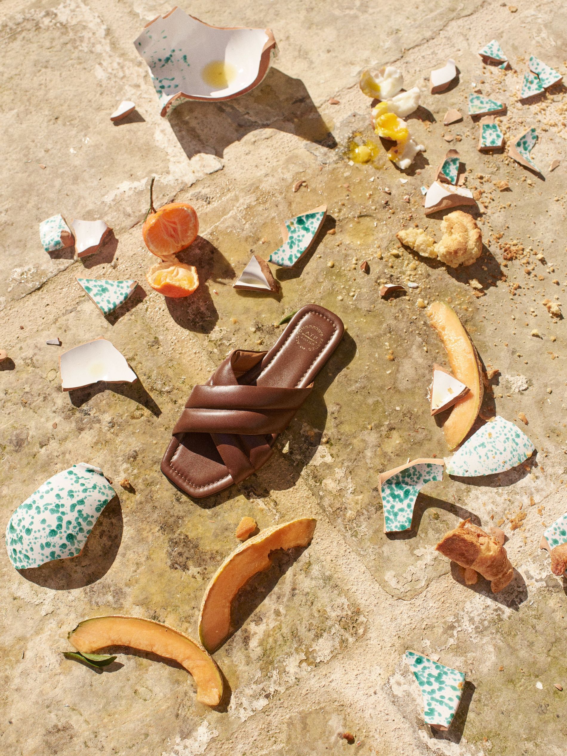 ATP Atelier sandal among the shards from a broken breakfast plate