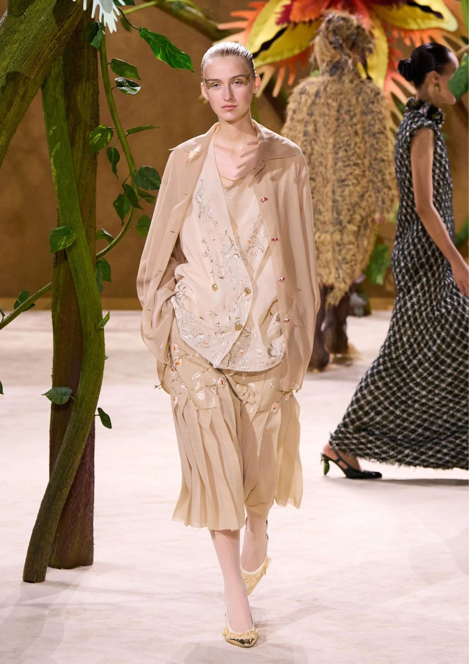 Sheer embellished blouse, a relaxed blazer, a pleated midi skirt, and pointed-toe pumps