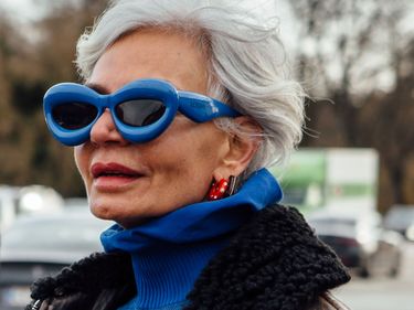 Guest wears blur Loewe bubble sunglasses with matching knitted top and an aviator jacket