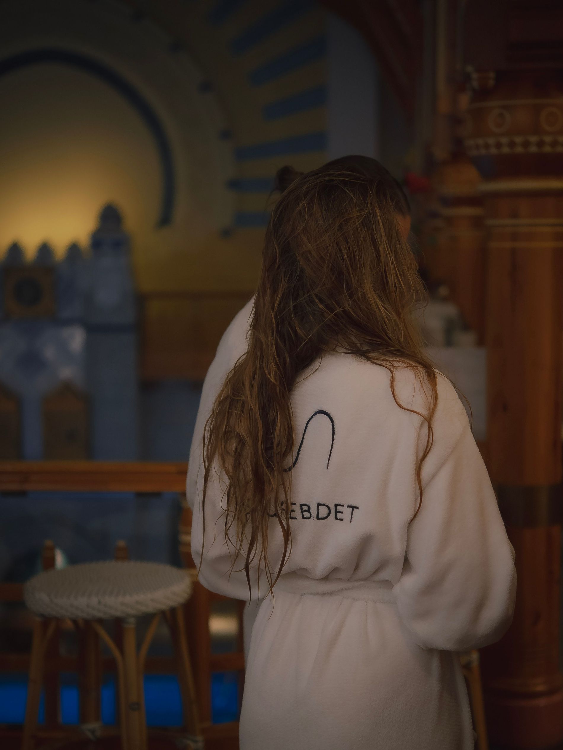 A woman wraps herself up in Sturebadet's white robe after a swim in the pool