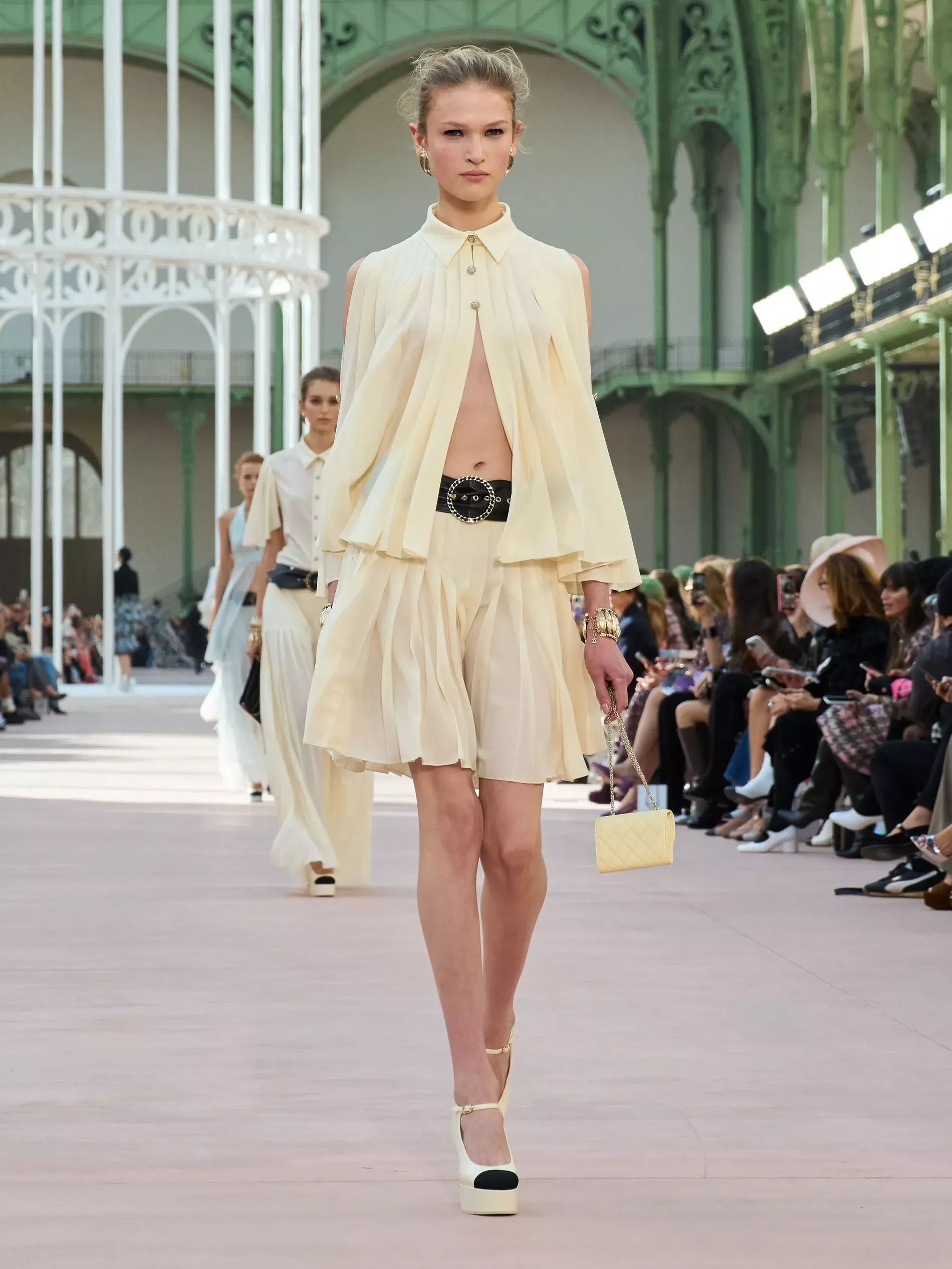 Chanel spring summer 2025 runway picturing a chiffon shirt and skirt in butter yellow 