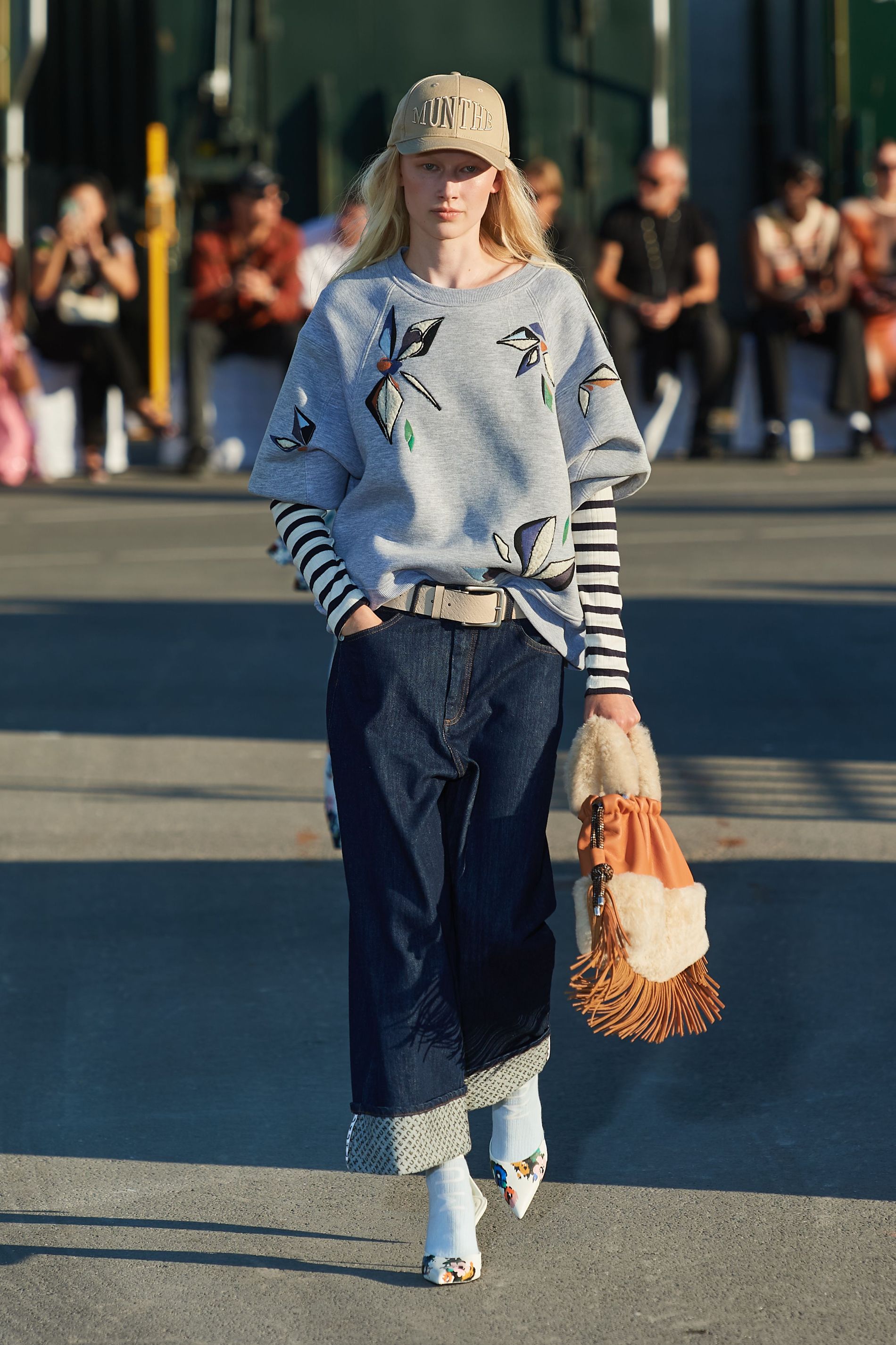 Model hold fringe bag with shearling details on Munthe's SS23 runway