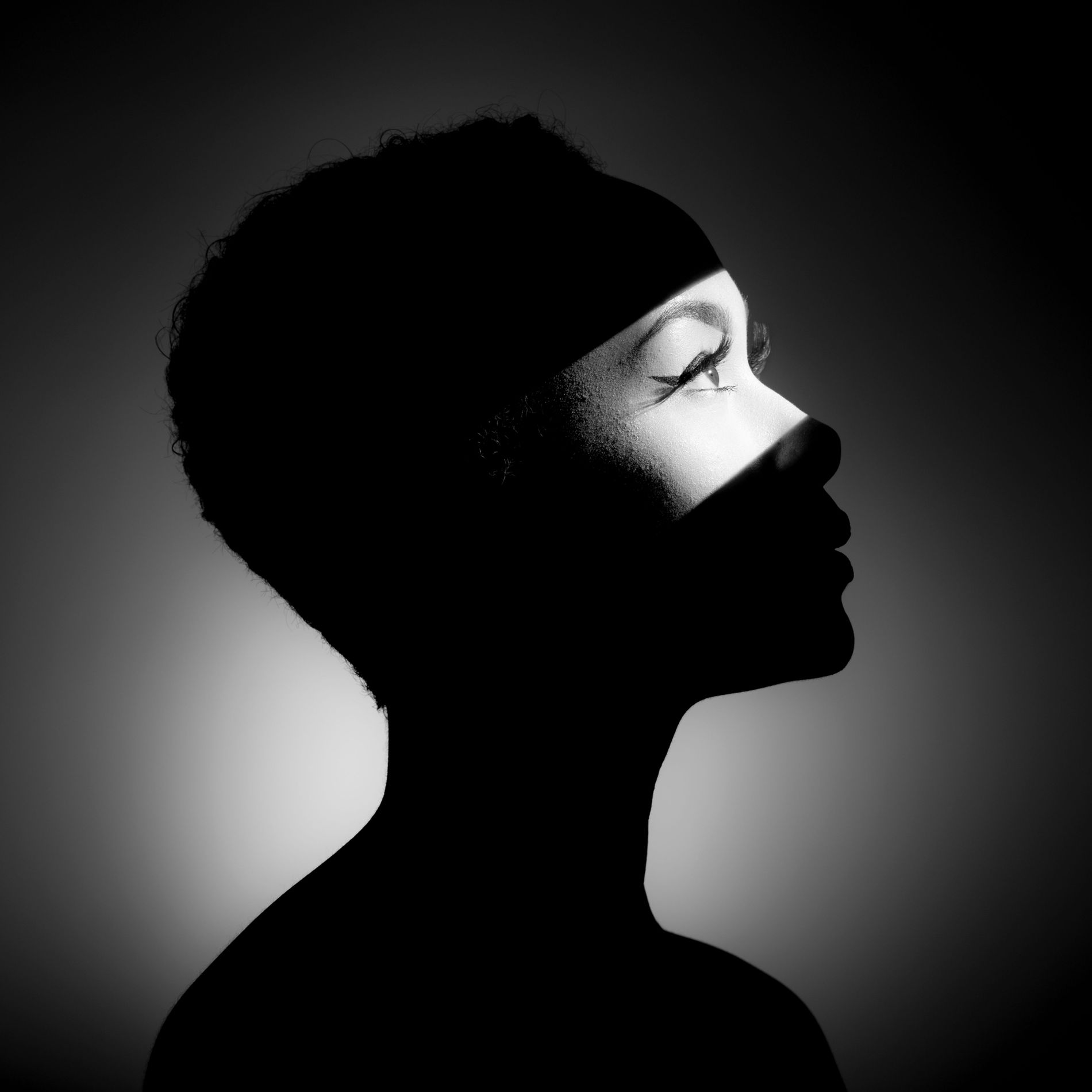 Black and white photo of woman with lit up eyes