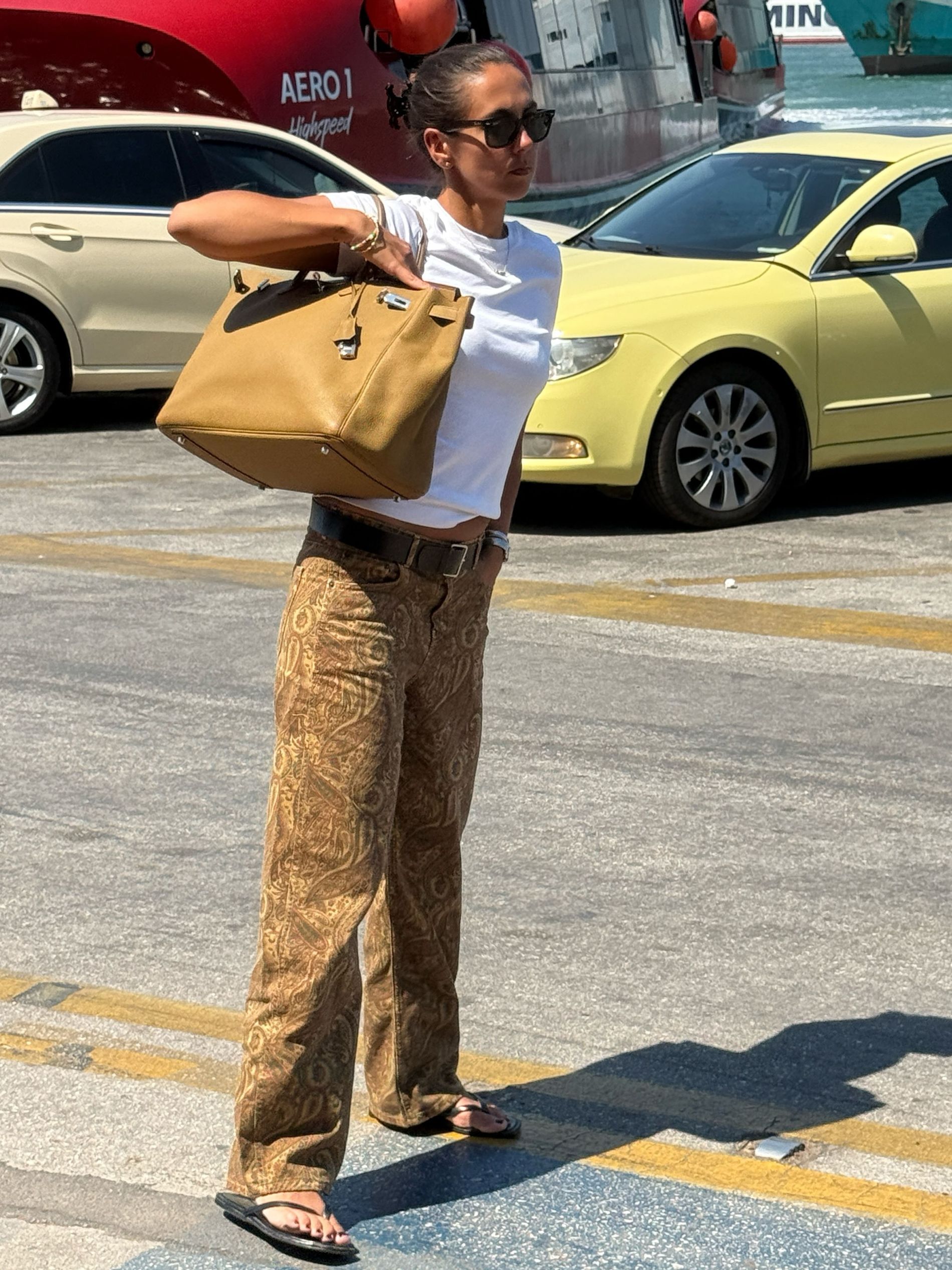 Hanna MW wears zara trousers, flip flops, hermes bag and white tee