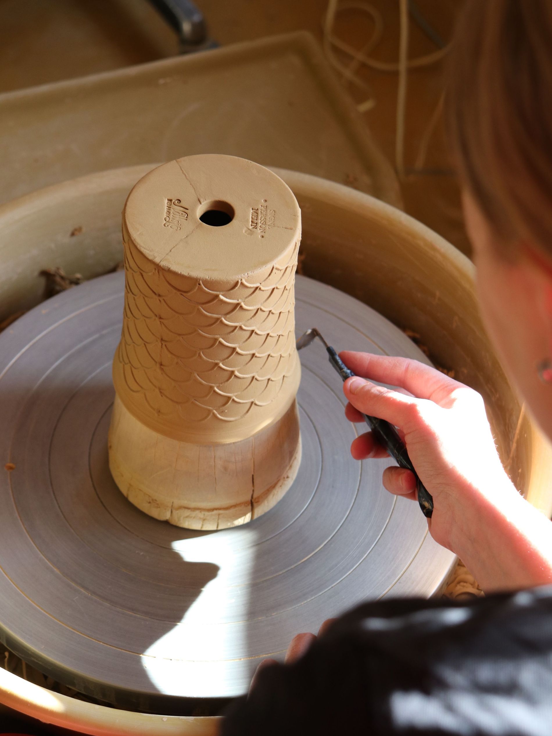 A woman crafting a vase at the Nittsjö Keramik factory