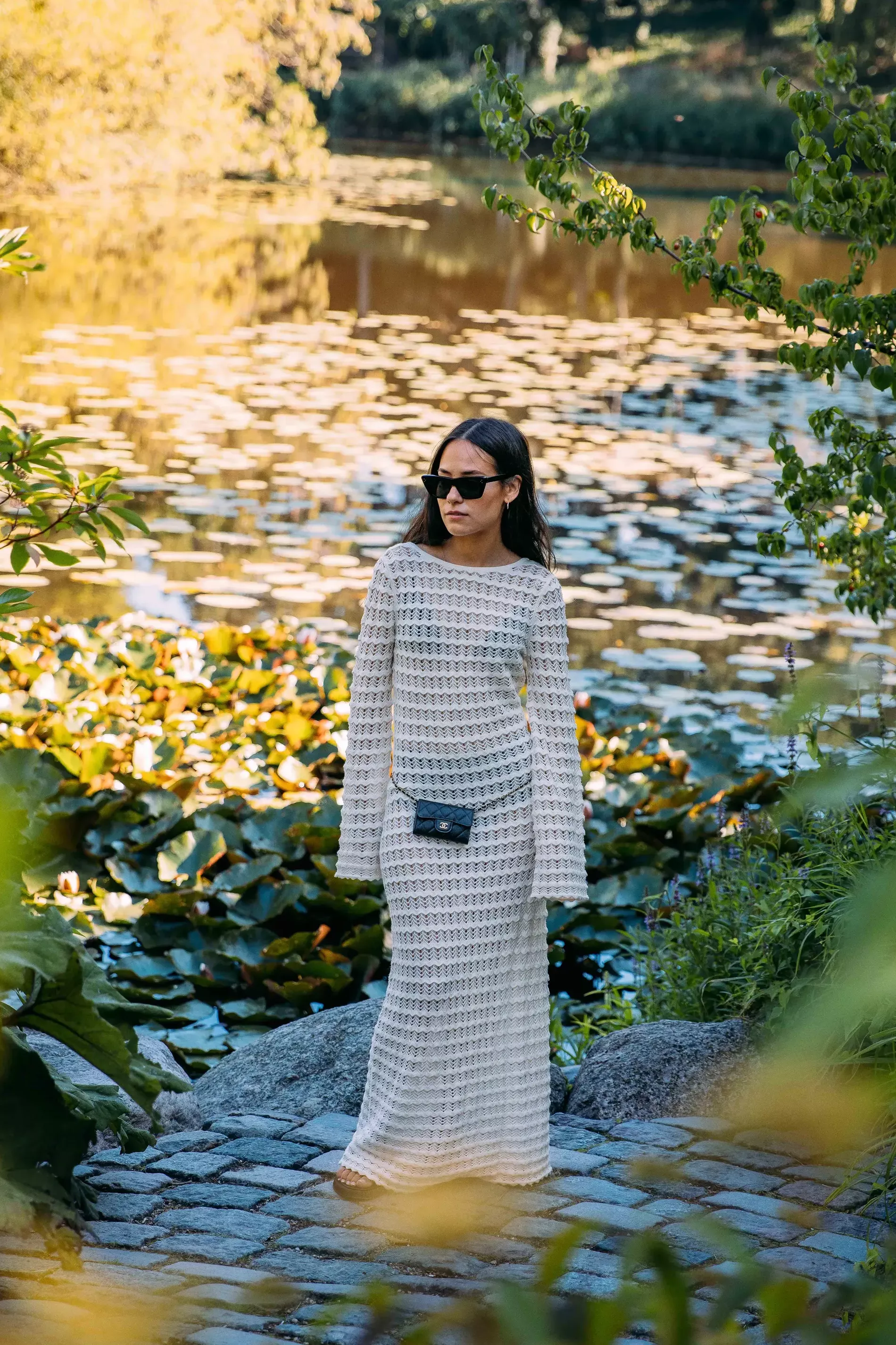 Copenhagen fashion week guest wears white crochet dress paired with Chanel 